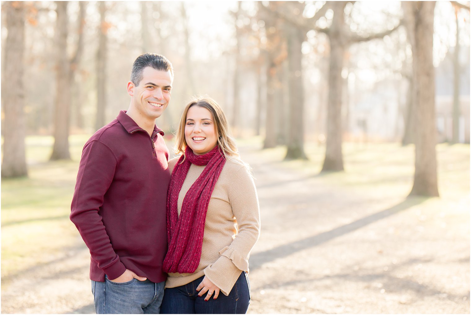 couple smiling for engagement photos at Allaire State Park in Wall NJ