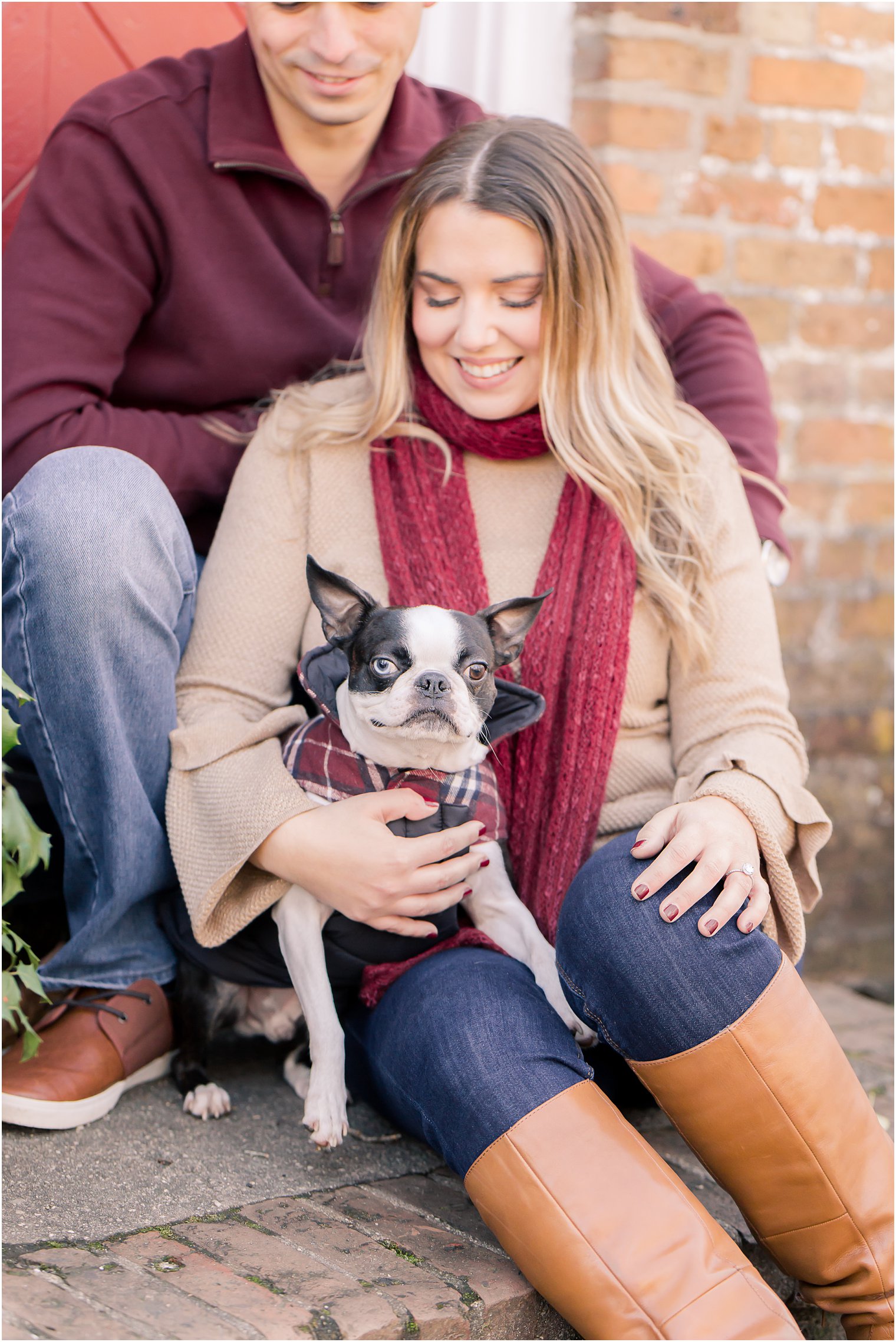 engagement photo with dog wearing plaid sweater