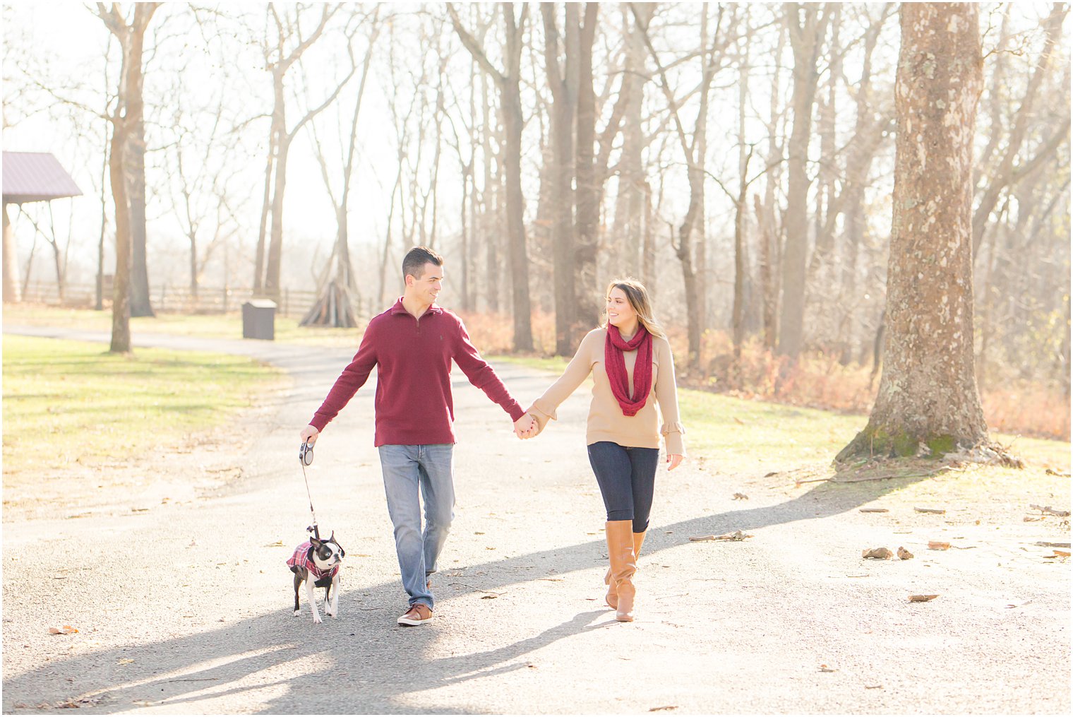 engaged couple walking their dog at Allaire State Park