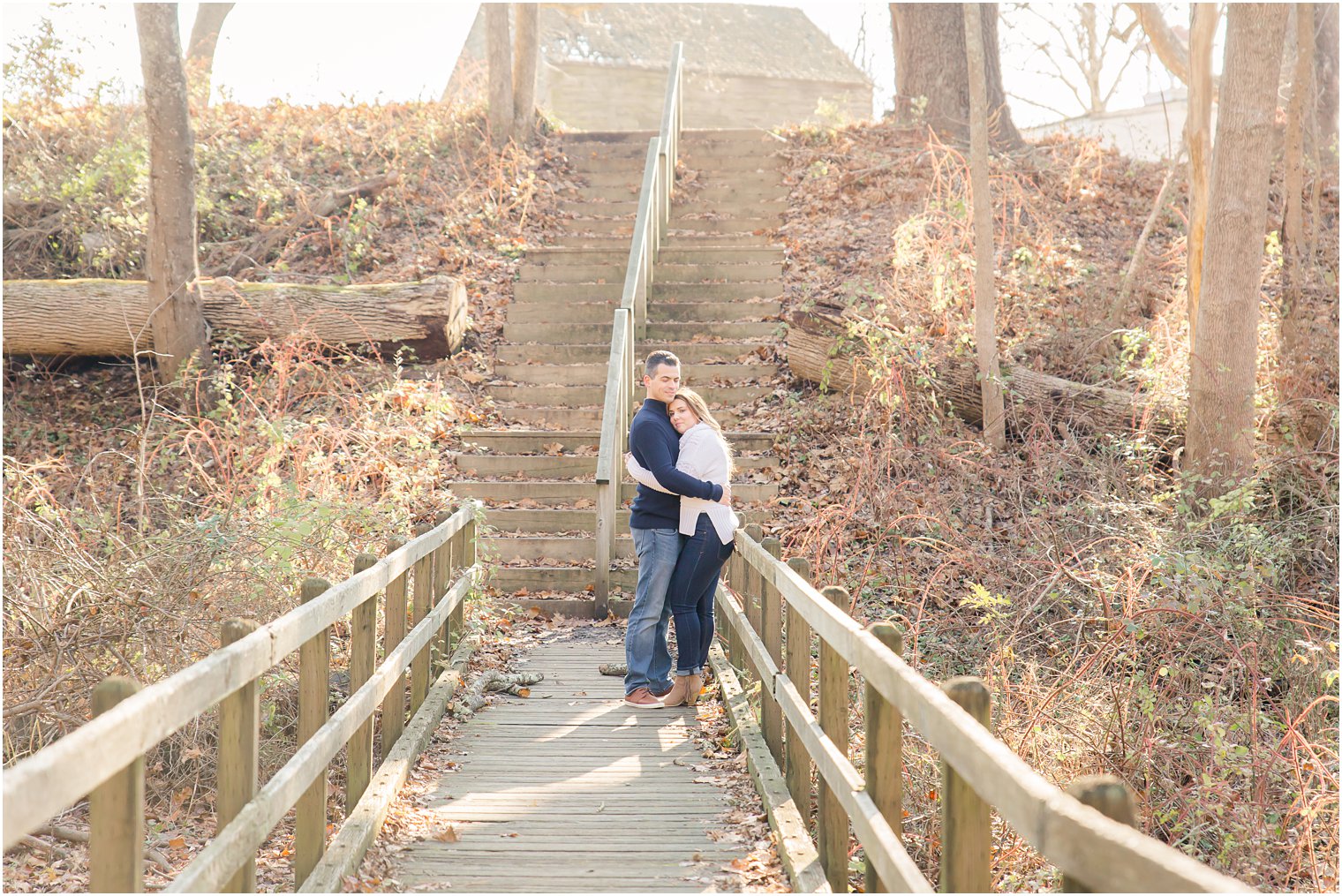 engagement photos on wooden bridge at Allaire State Park