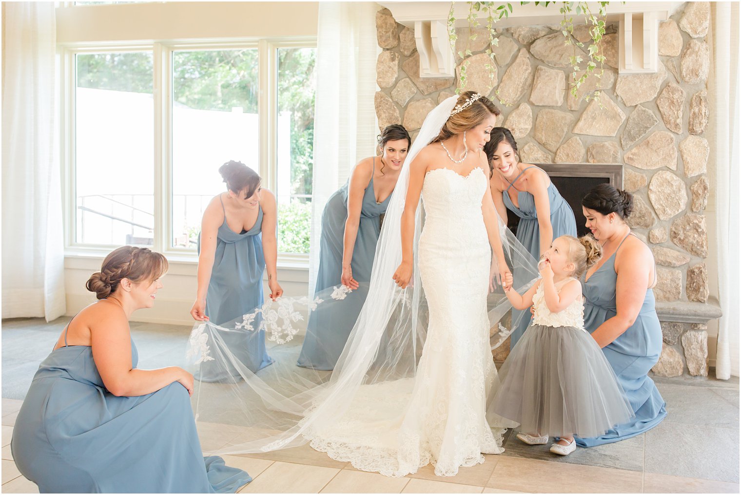 bridesmaids helping bride get dressed