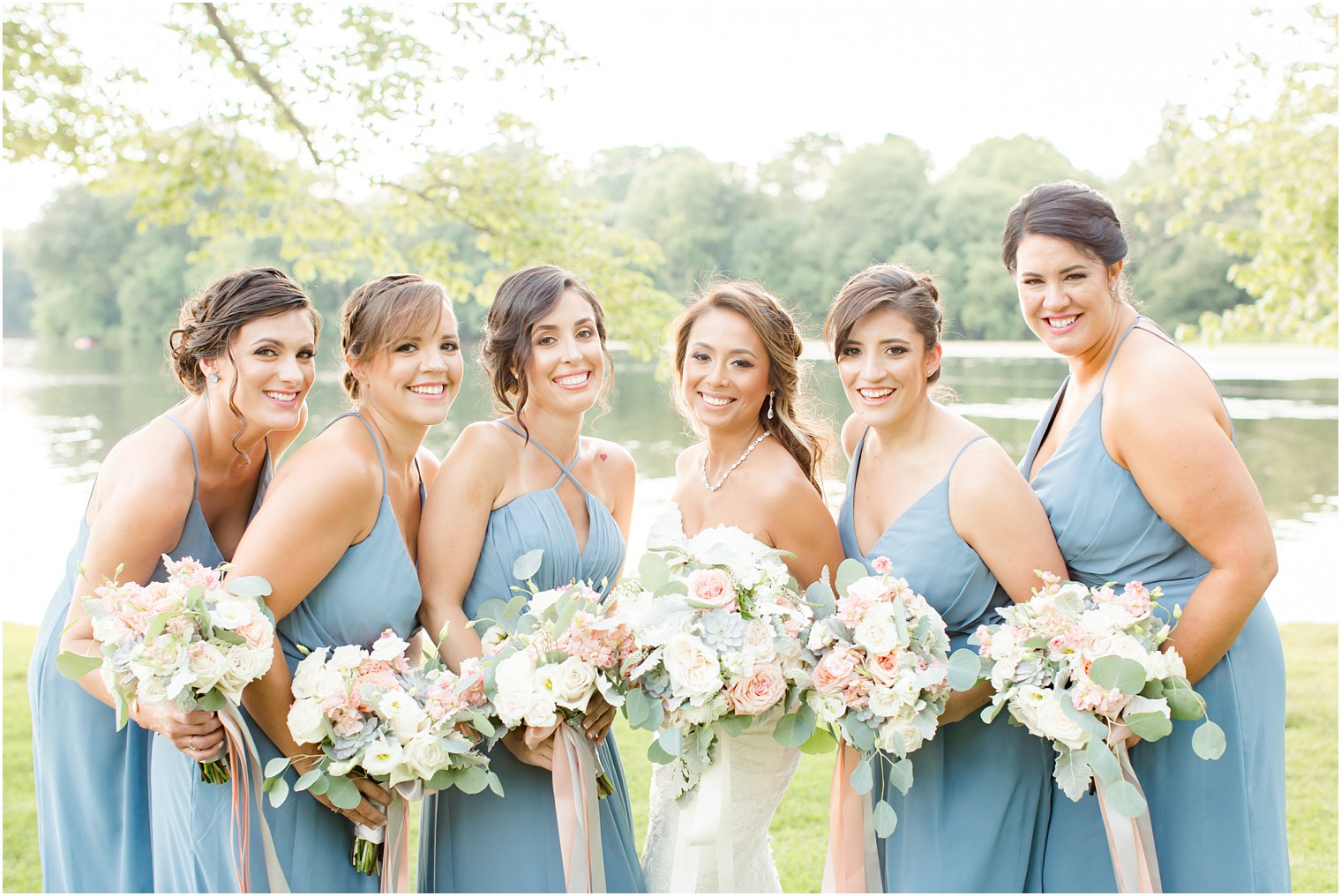 bridesmaids and pastel colored bouquets