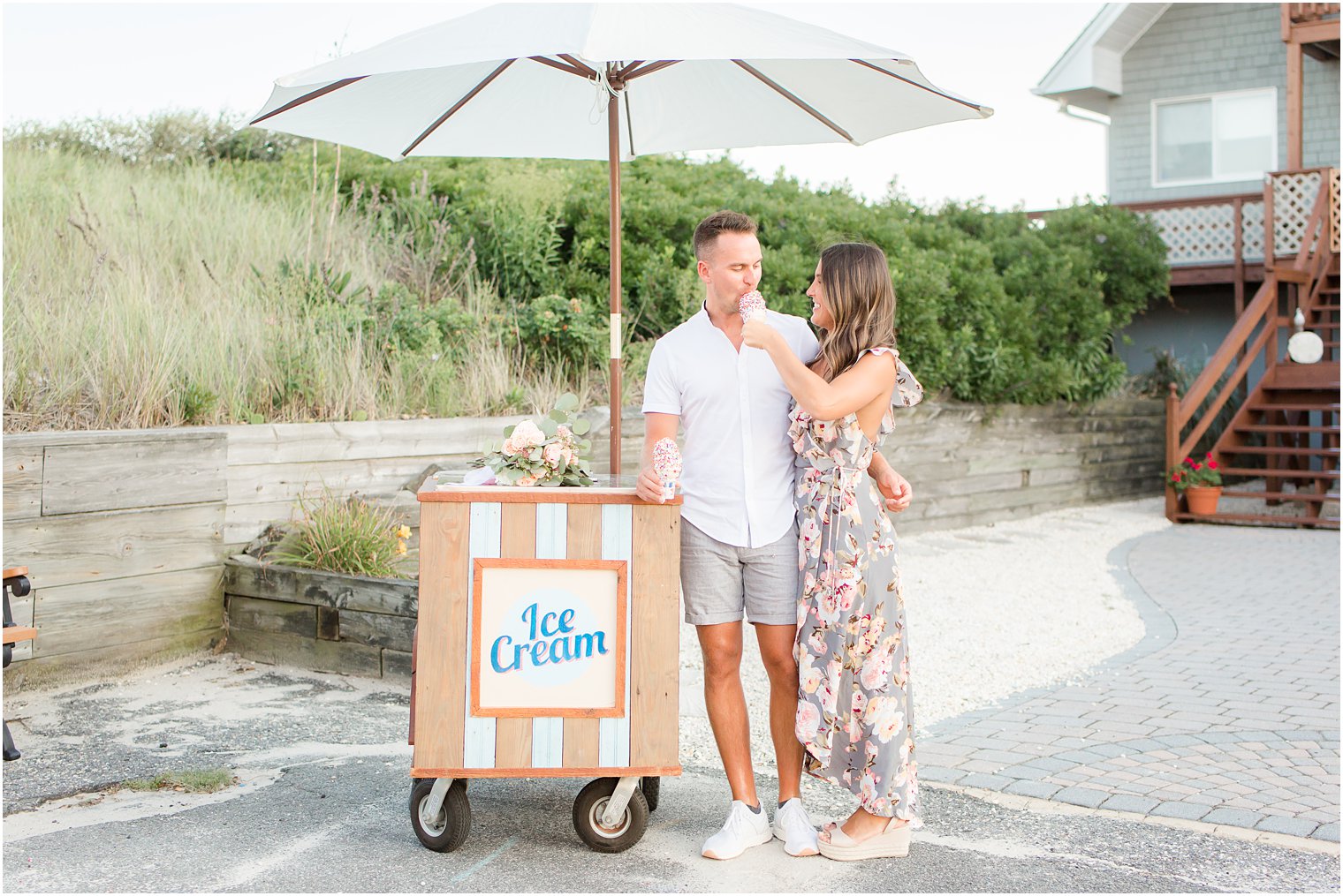 couple feeding each other ice cream during engagement session 