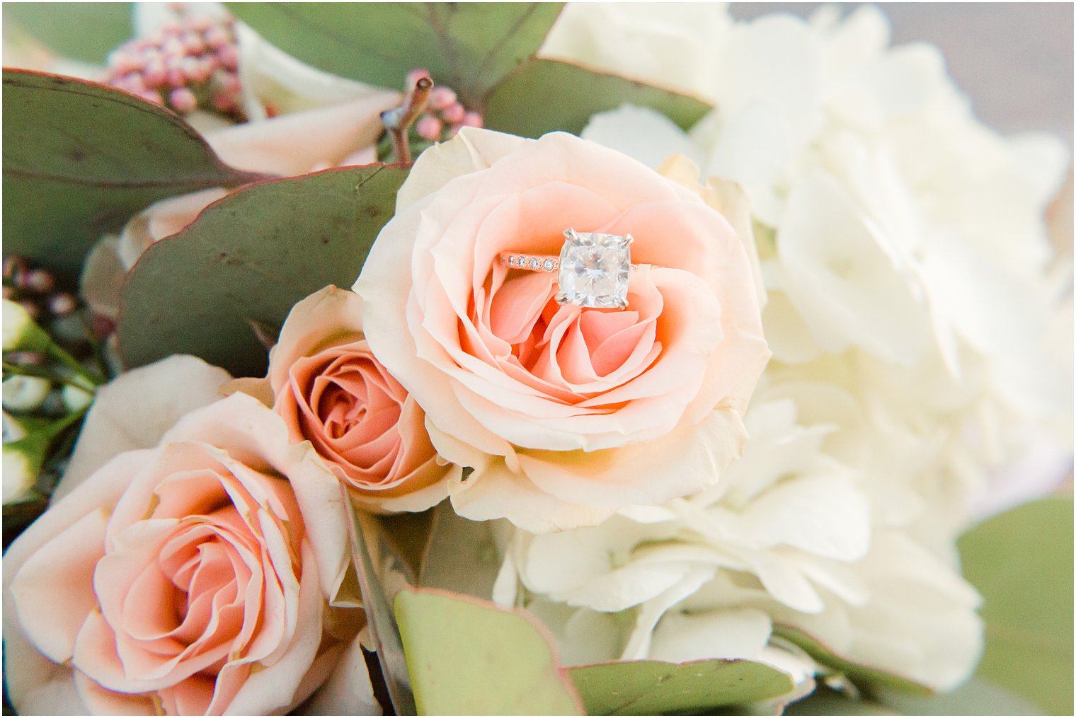 engagement ring in a bouquet by Lily in the Valley