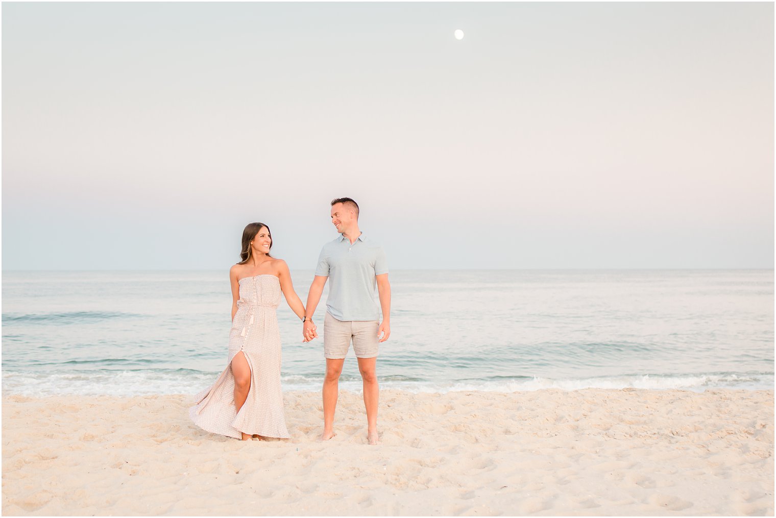engaged couple on the beach at sunset