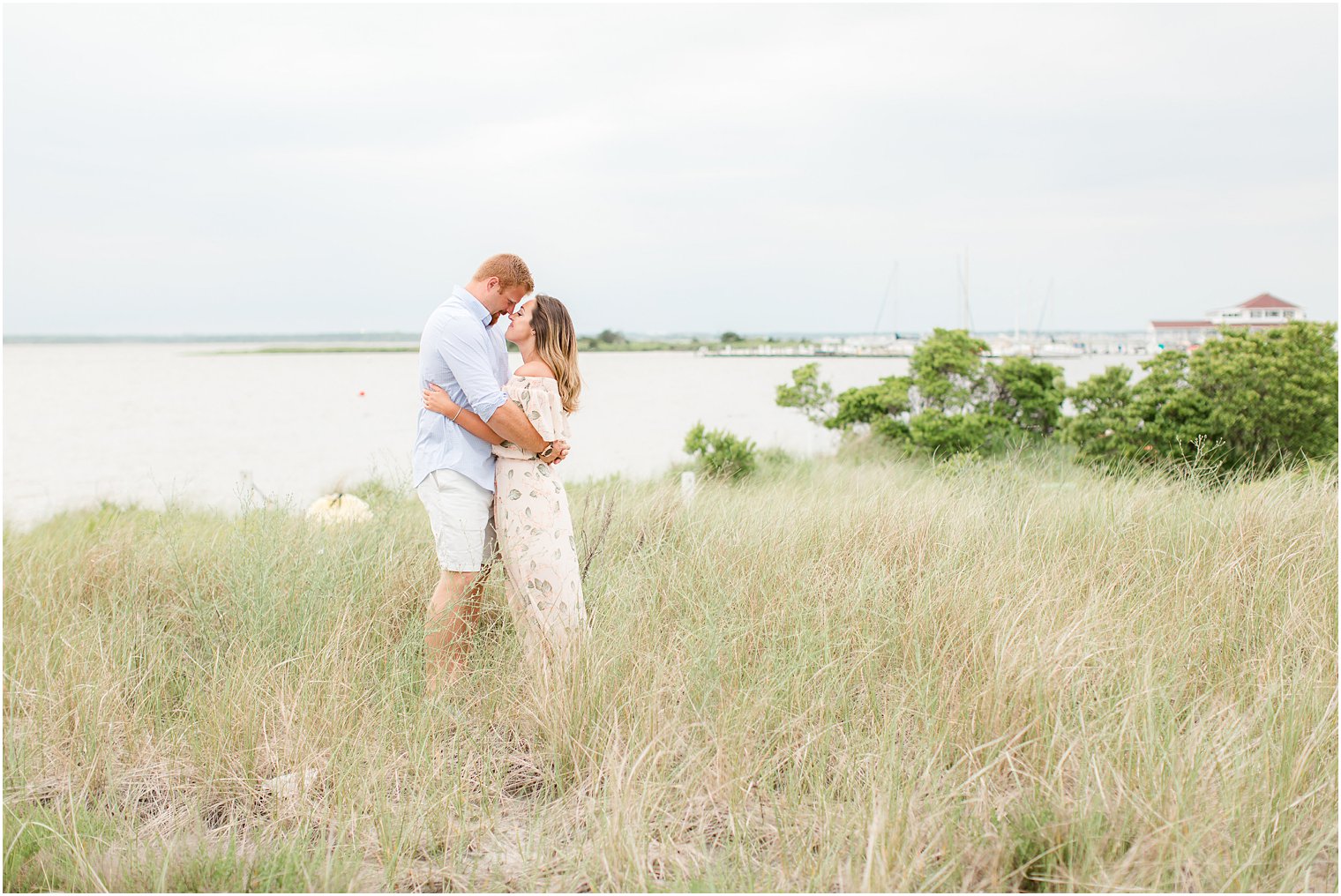 romantic engagement photo with tall grasses