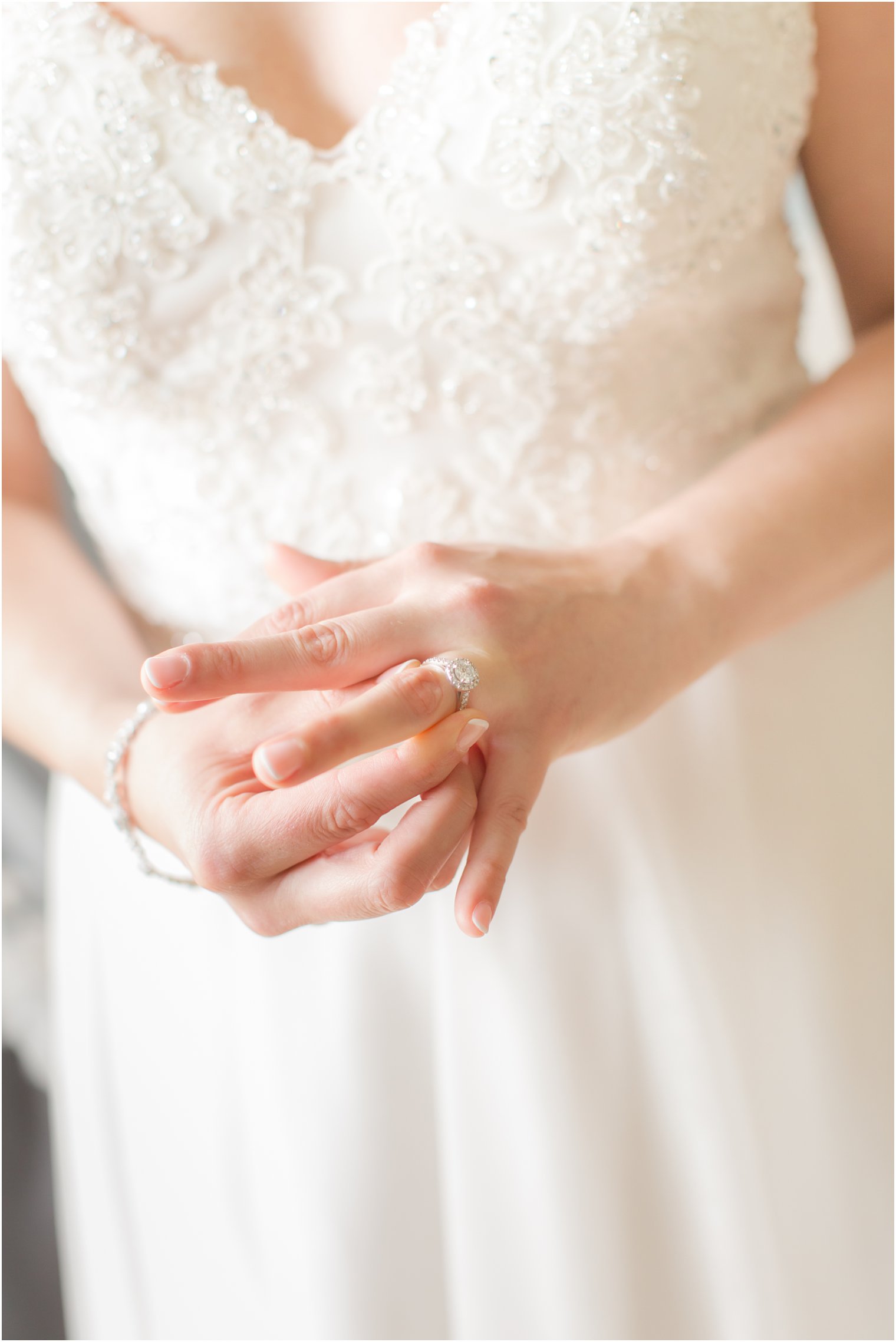 Bride putting on her engagement ring