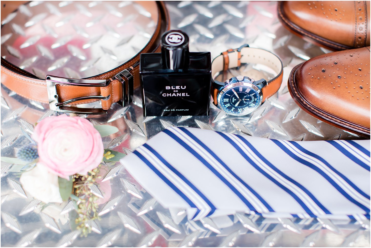 Groom's tie, watch, and boutonniere for wedding day