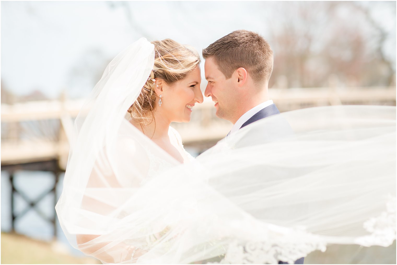 Romantic veil photo of bride and groom at Divine Park in Spring Lake 