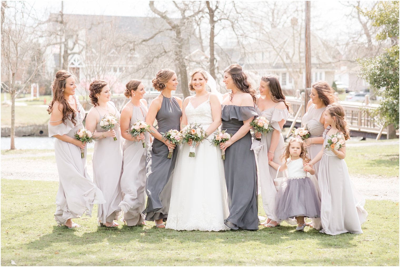 Bridesmaids wearing dresses in shades of gray