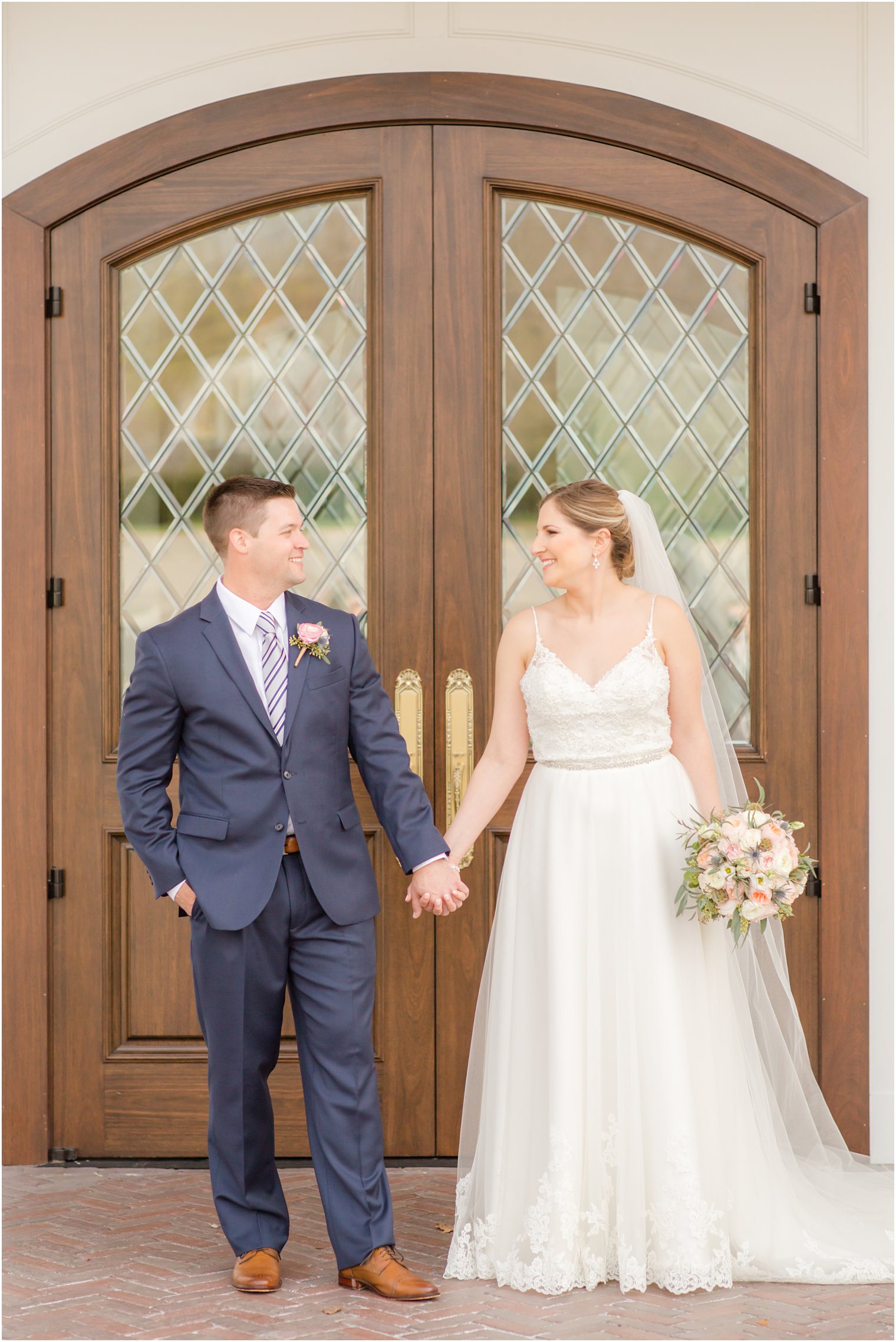 Bride and groom walking in front of The Mill Lakeside Manor