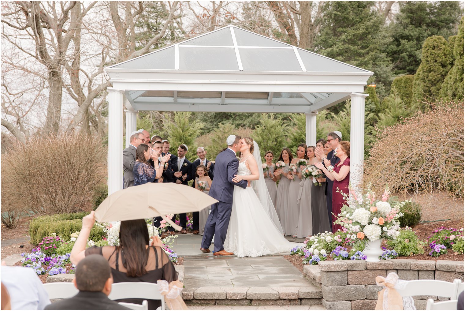 Groom and bride kissing during ceremony at The Mill Lakeside Manor Wedding