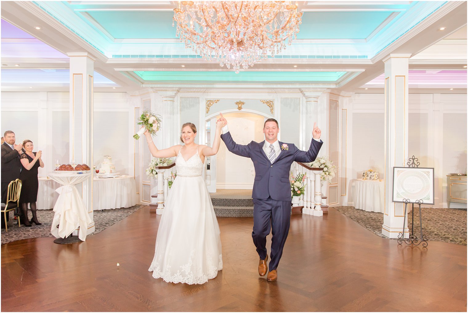 Bride and groom walking into reception at The Mill Lakeside Manor