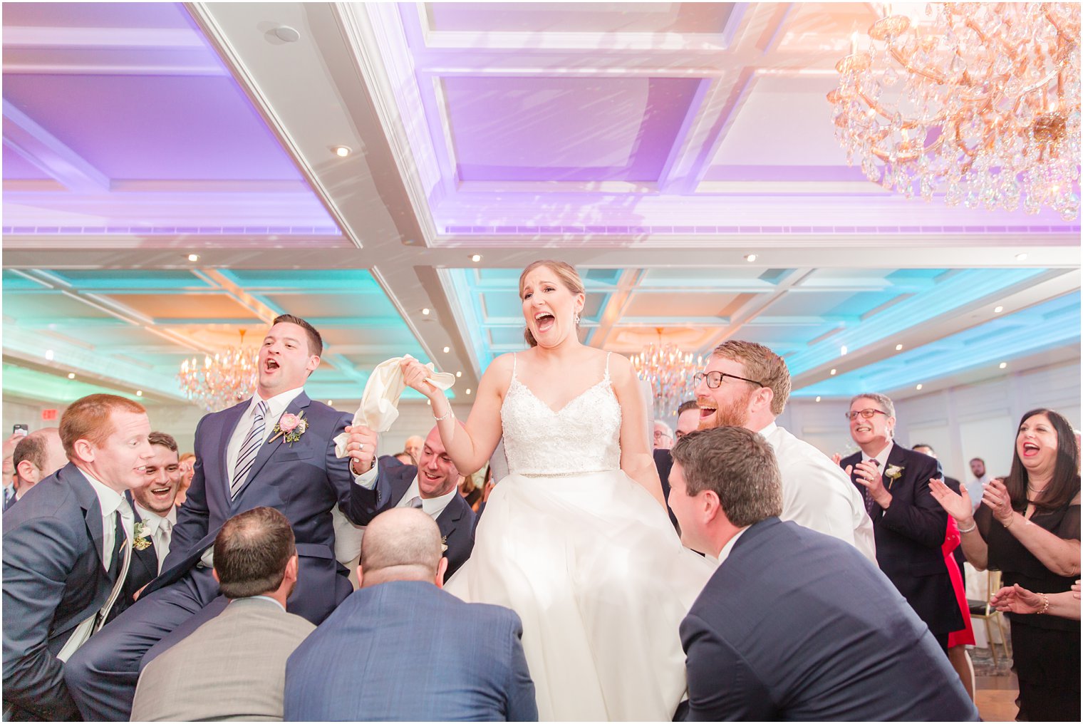 Bride and groom dancing hora 