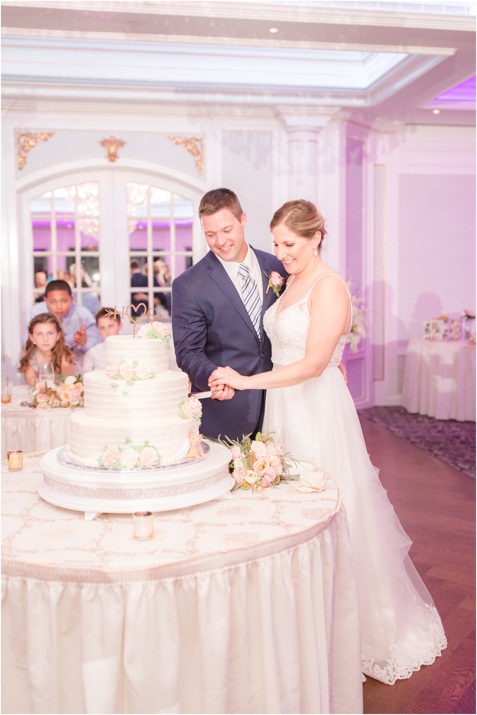 Bride and groom cutting cake during wedding reception at The Mill at Lakeside Manor in Spring Lake NJ