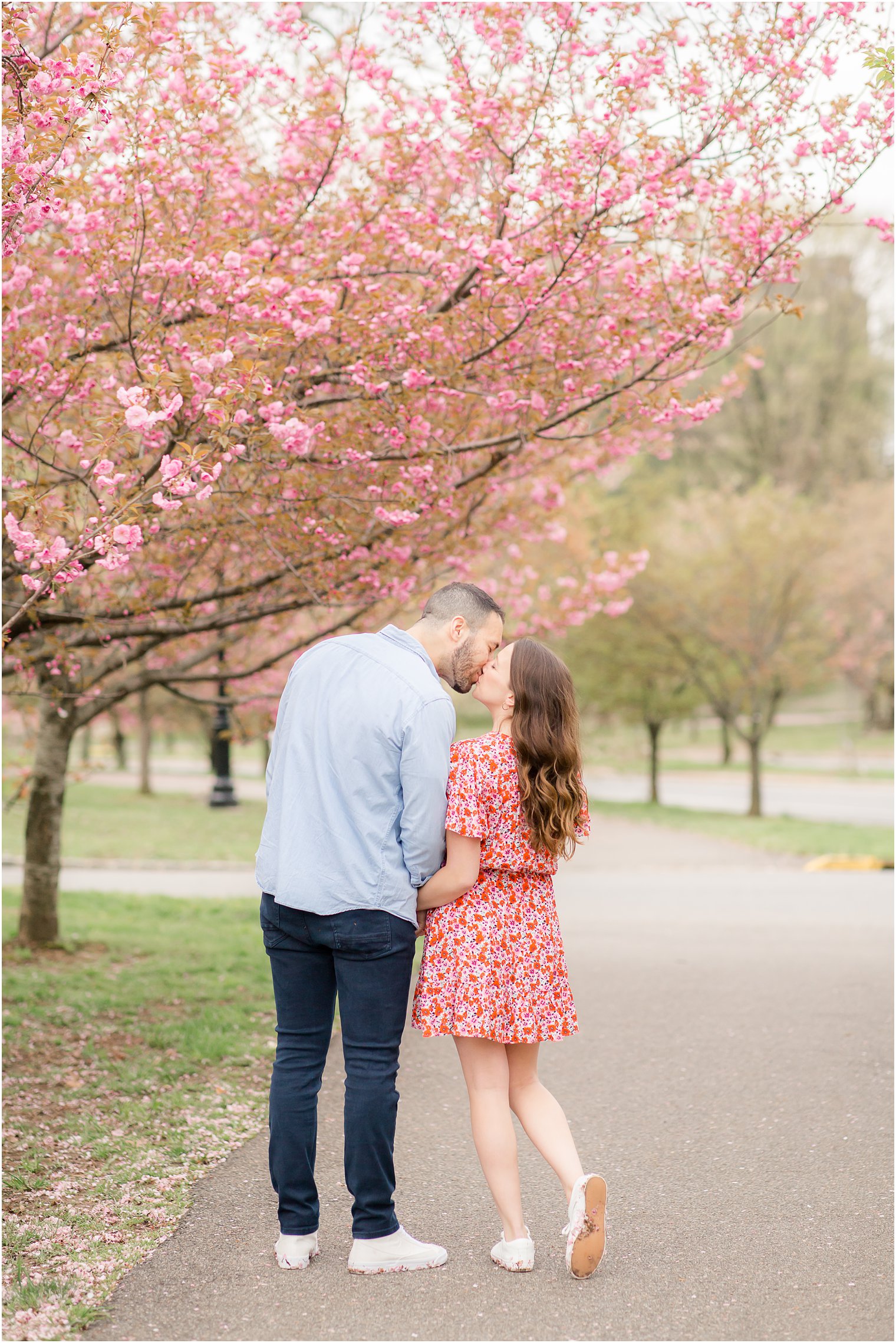 Engaged couple at Branch Brook Park in Newark NJ during cherry blossoms