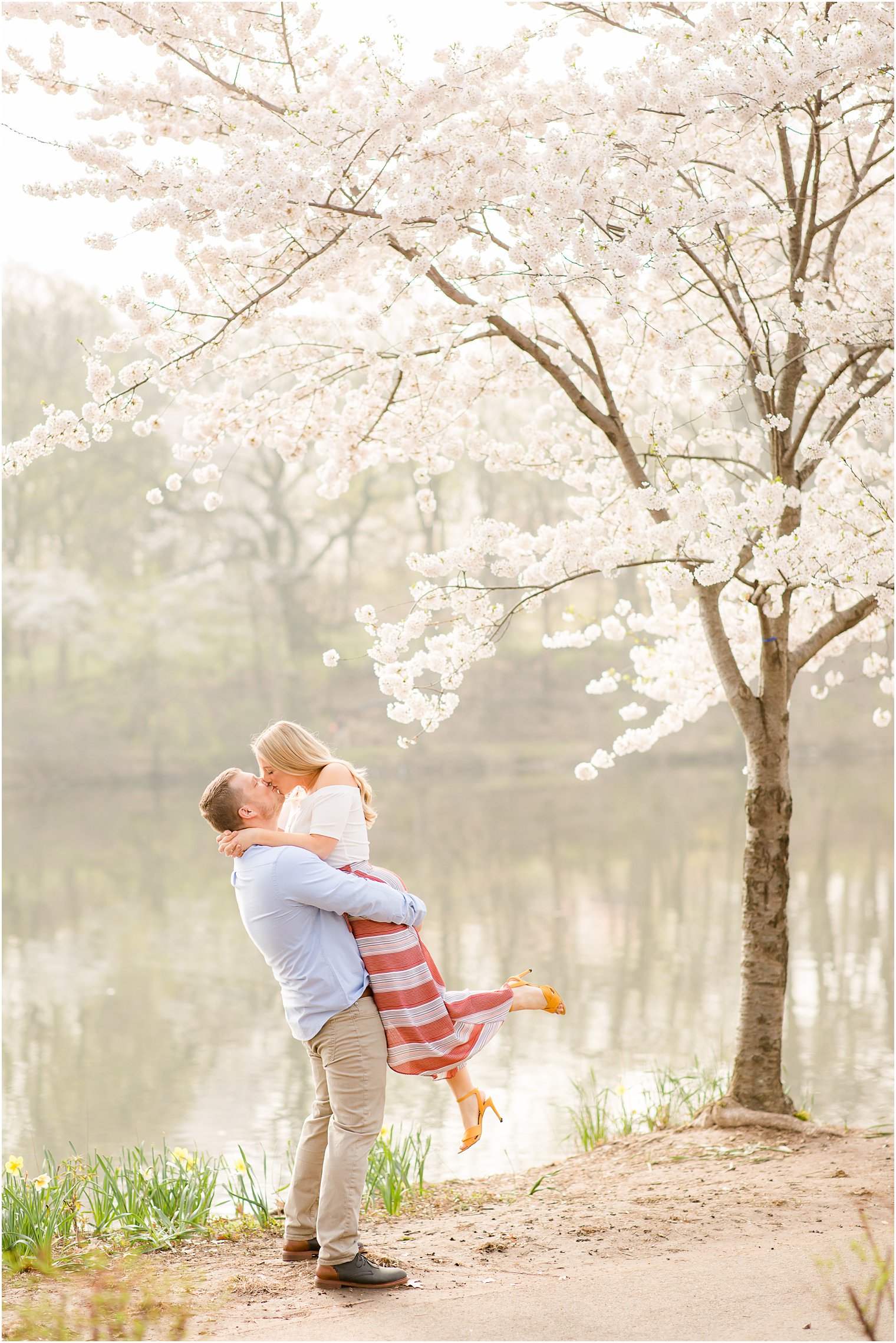 Man lifting bride for engagement photos