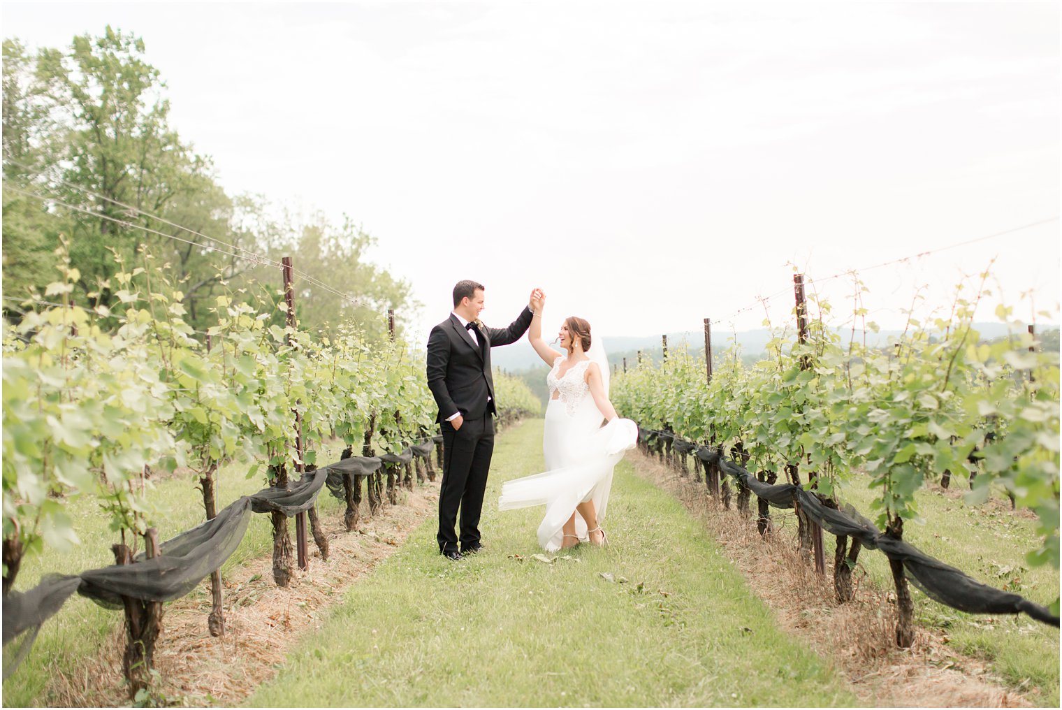 groom twirling bride in Stone Tower Winery Wedding Photos by Idalia Photography