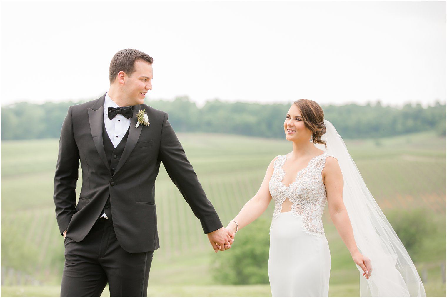 bride and groom walking in Stone Tower Winery Wedding Photos by Idalia Photography
