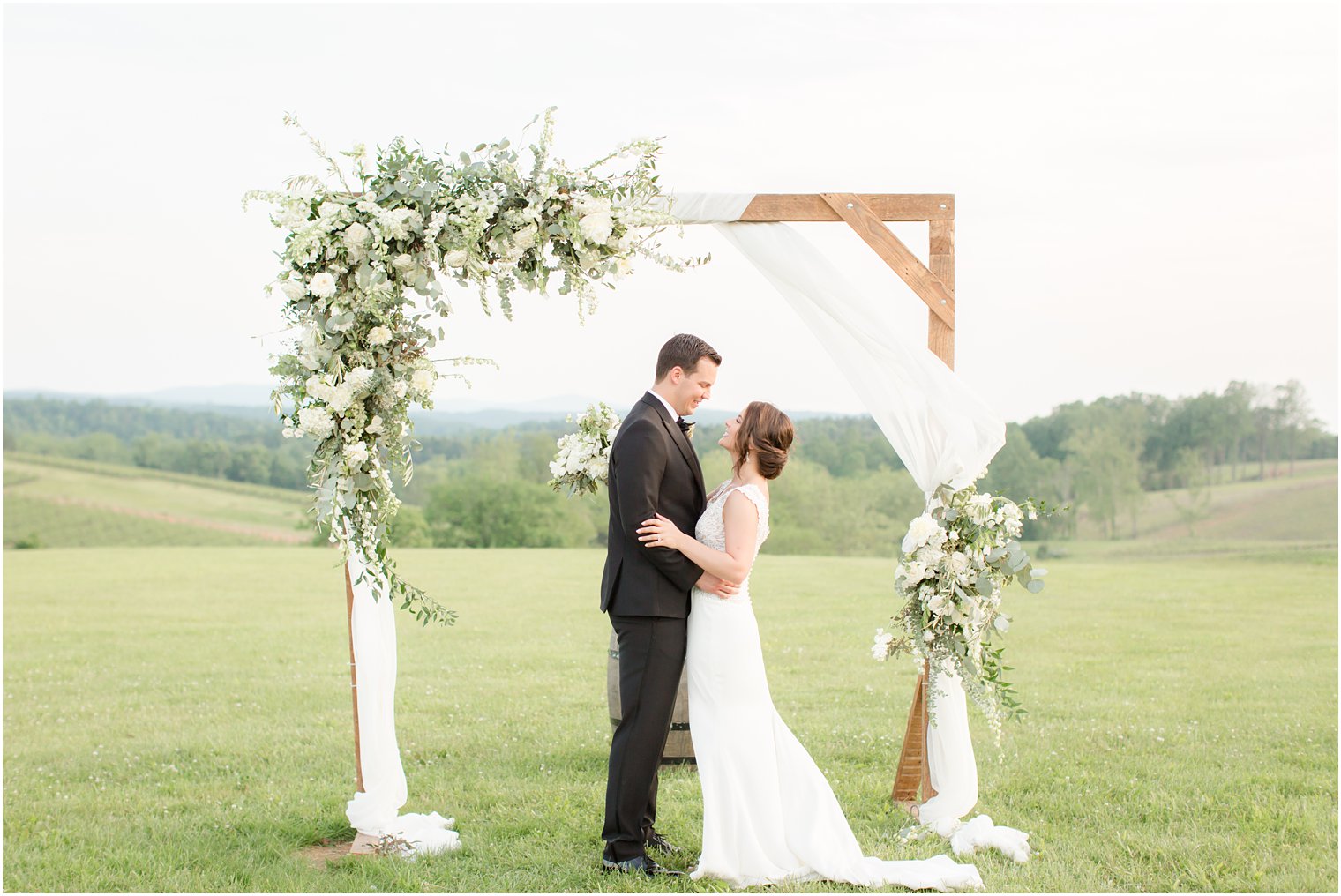 couple under arbor in Stone Tower Winery Wedding Photos by Idalia Photography