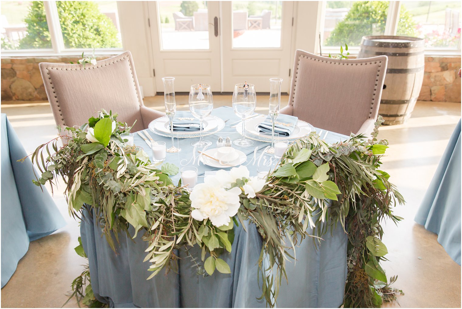 sweetheart table with greenery in Stone Tower Winery Wedding Photos by Idalia Photography