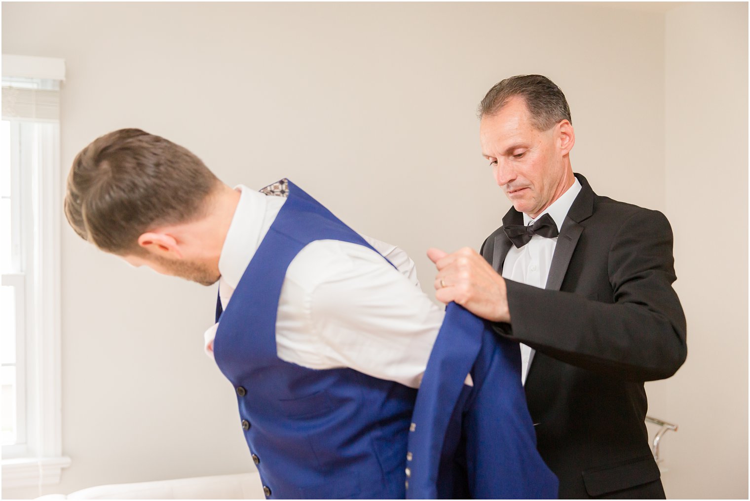 groom getting ready with his father