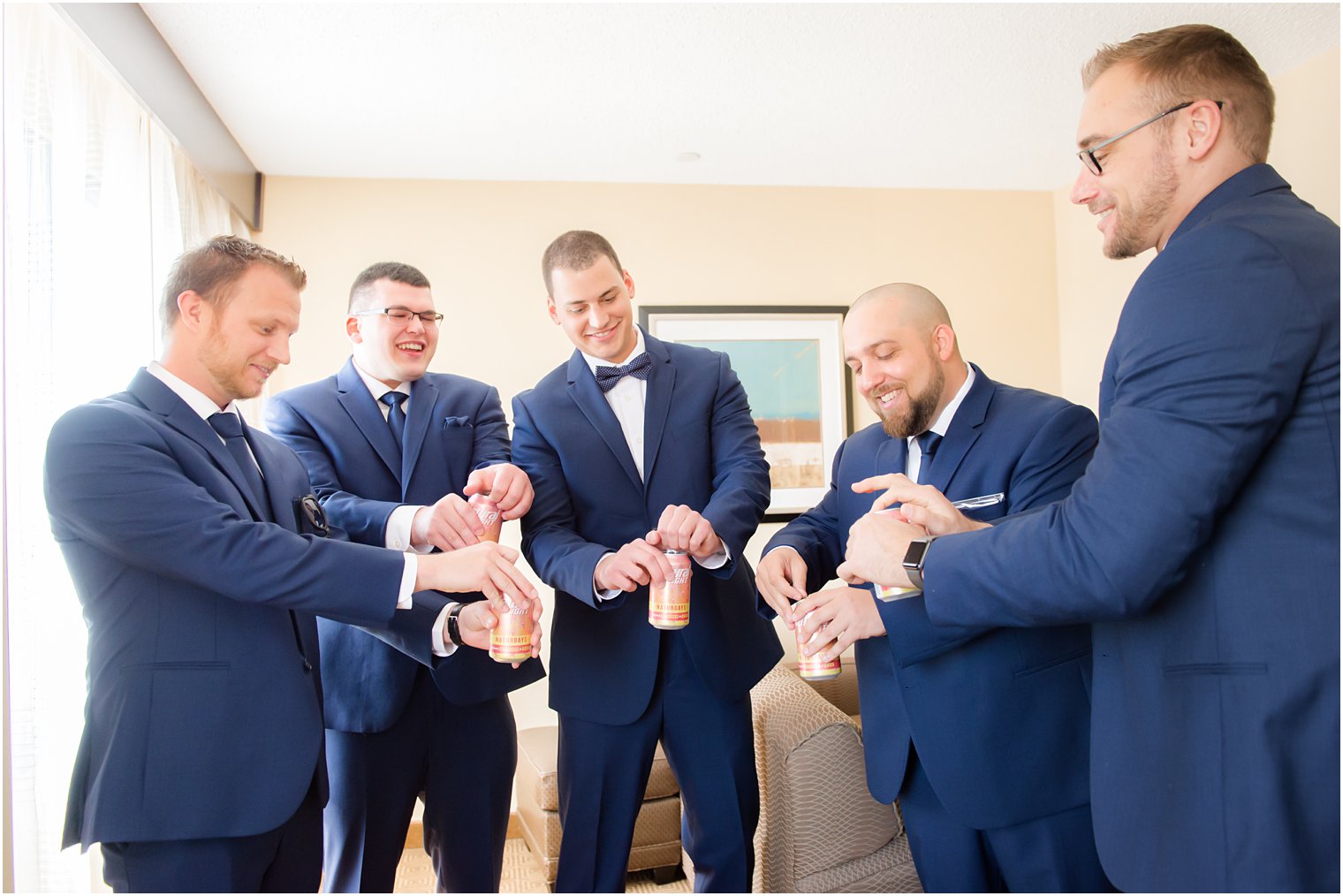 Groom and groomsmen toasting before wedding day