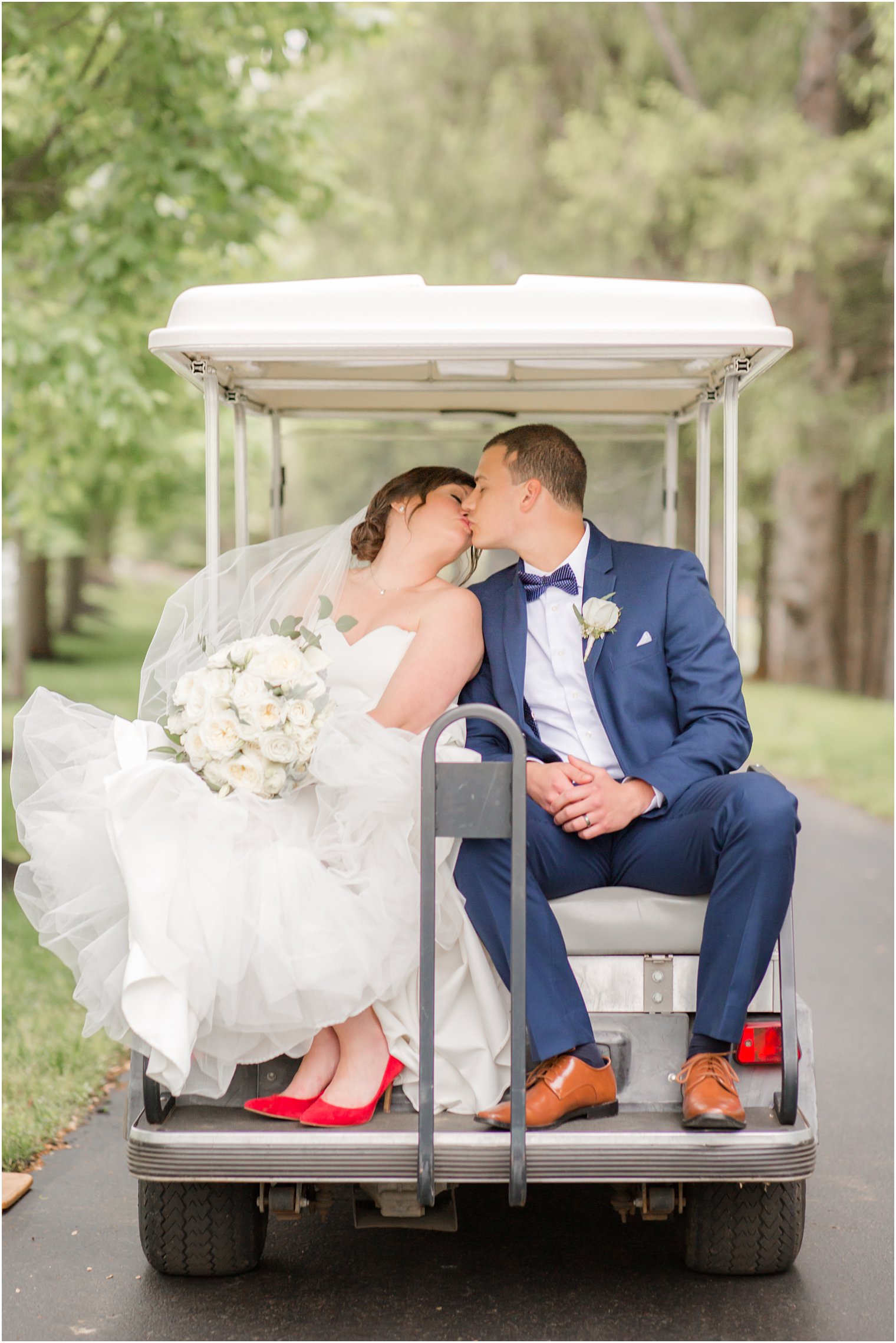 Bride and groom in golf cart at Windows on the Water at Frogbridge in Millstone NJ