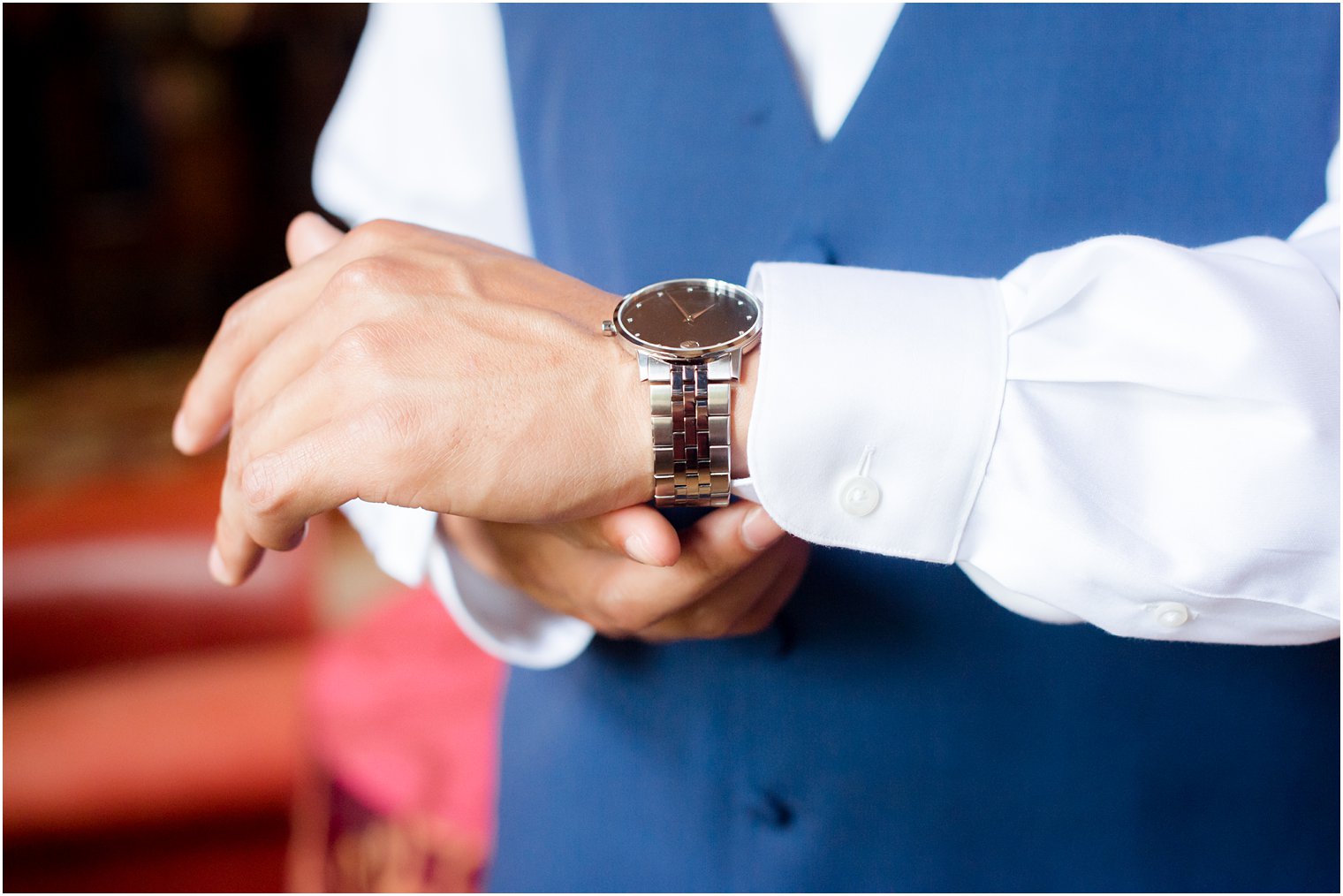 groom putting on watch in The Castle at Skylands Manor Wedding Photos by Idalia Photography