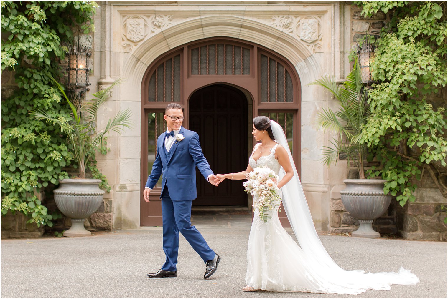 bride and groom walking | The Castle at Skylands Manor Wedding Photos by Idalia Photography