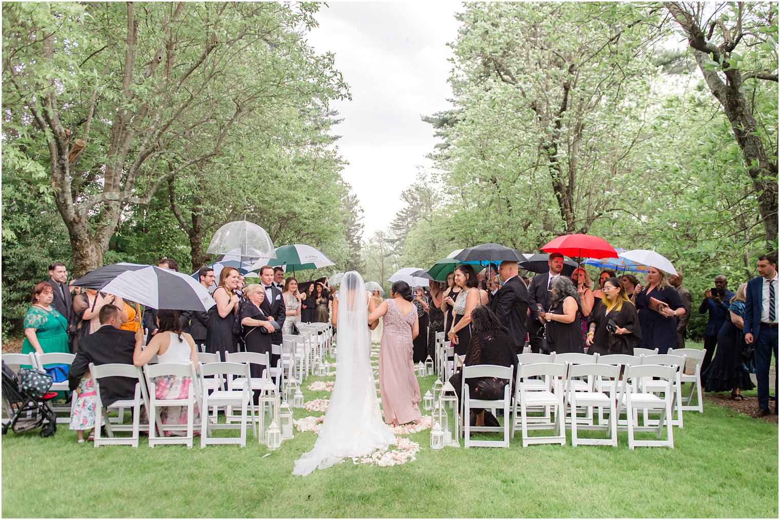 bride walking down the aisle at at rainy day wedding at The Castle at Skylands Manor