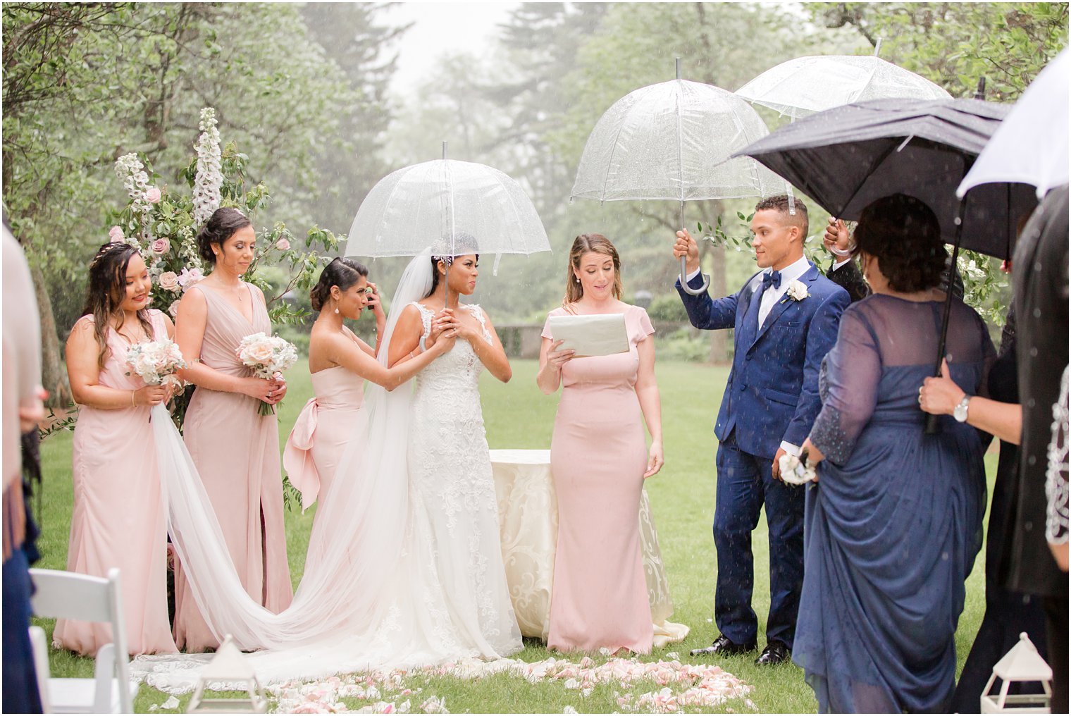 outdoor wedding ceremony at rainy day wedding at The Castle at Skylands Manor