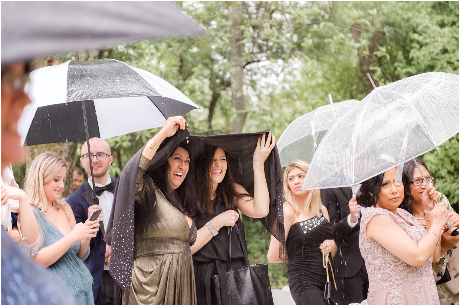 guests at rainy day wedding at The Castle at Skylands Manor