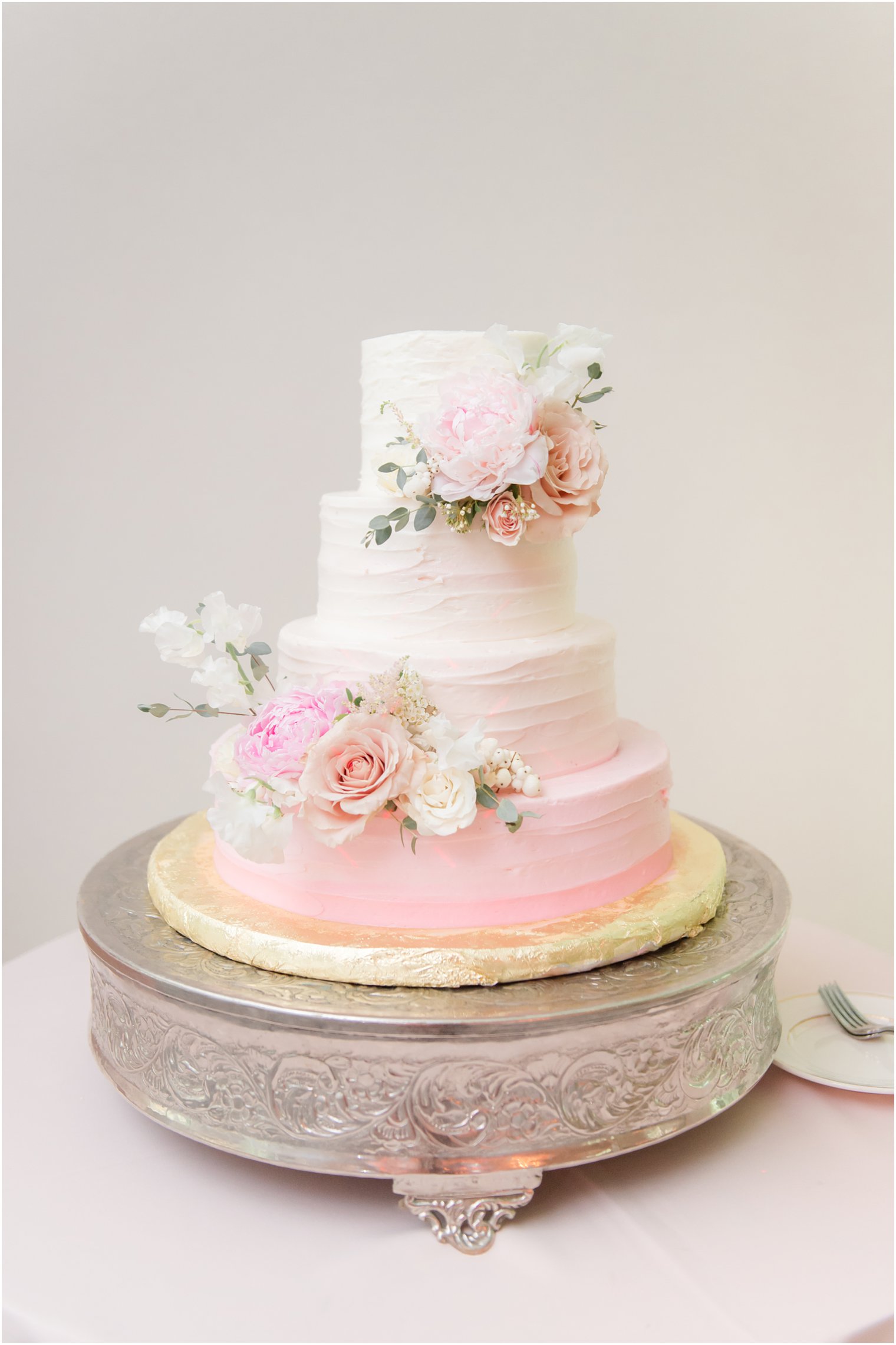 wedding cake with florals at Castle at Skylands Manor