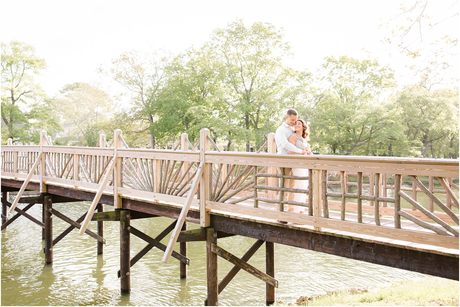 Engaged couple on a bridge in Spring Lake NJ by Spring Lake Wedding Photographer