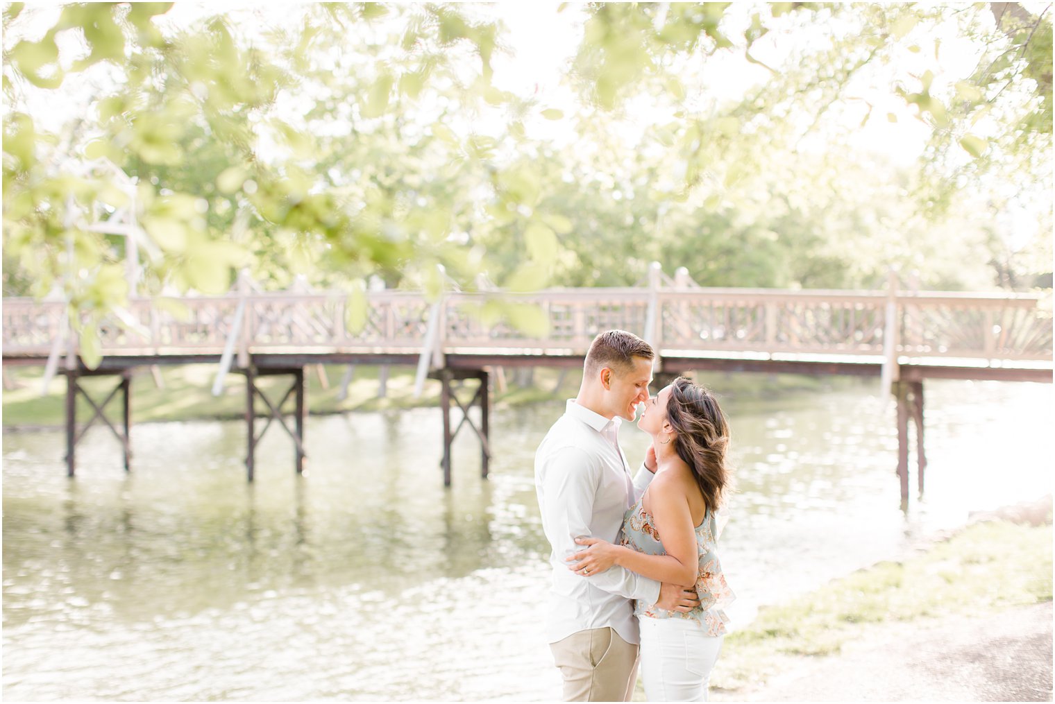 Engaged couple on a bridge in Spring Lake NJ by Spring Lake Wedding Photographer