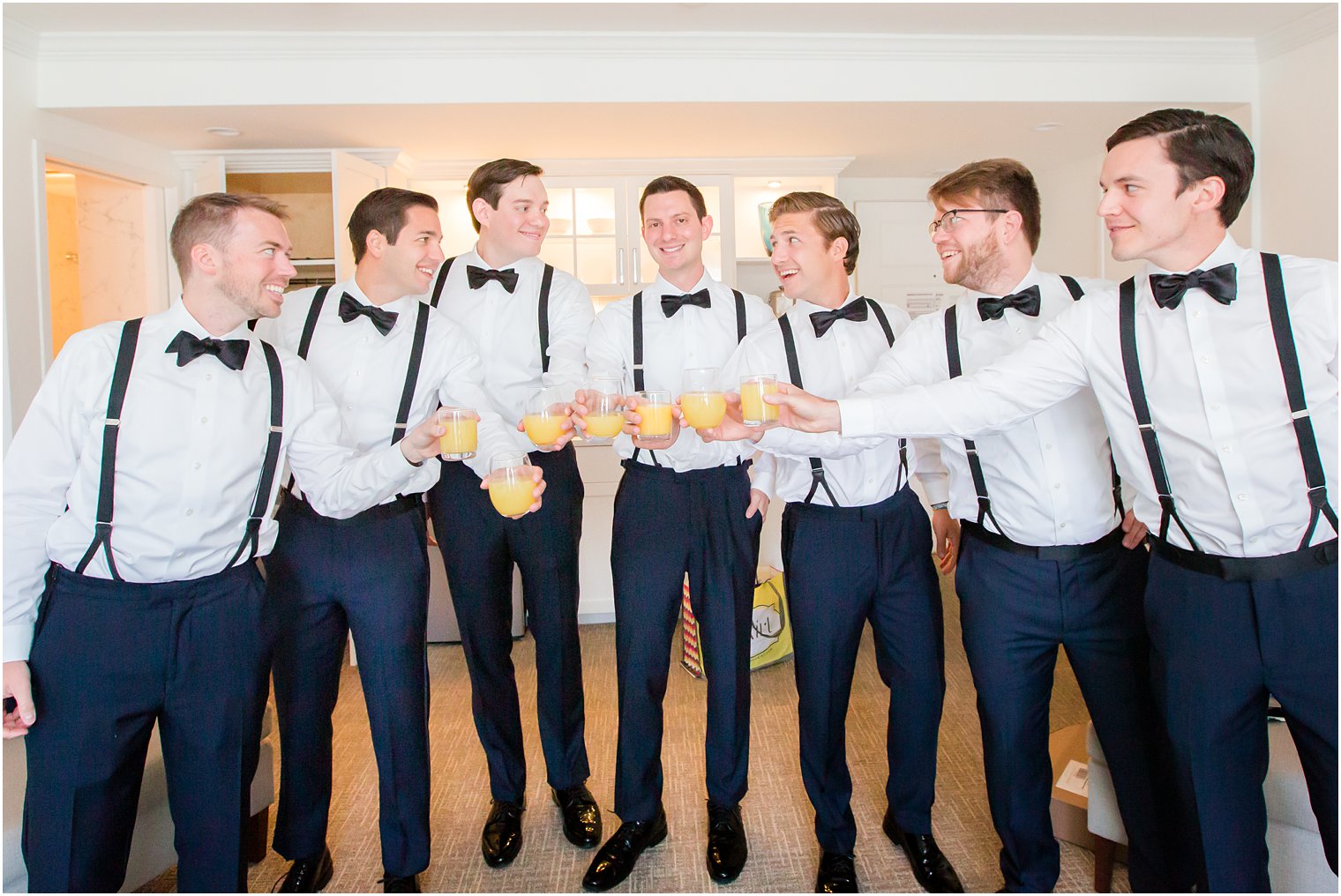Groomsmen toasting at ICONA Beach Resort