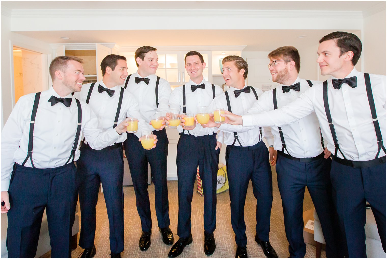 Groomsmen toasting at ICONA Beach Resort