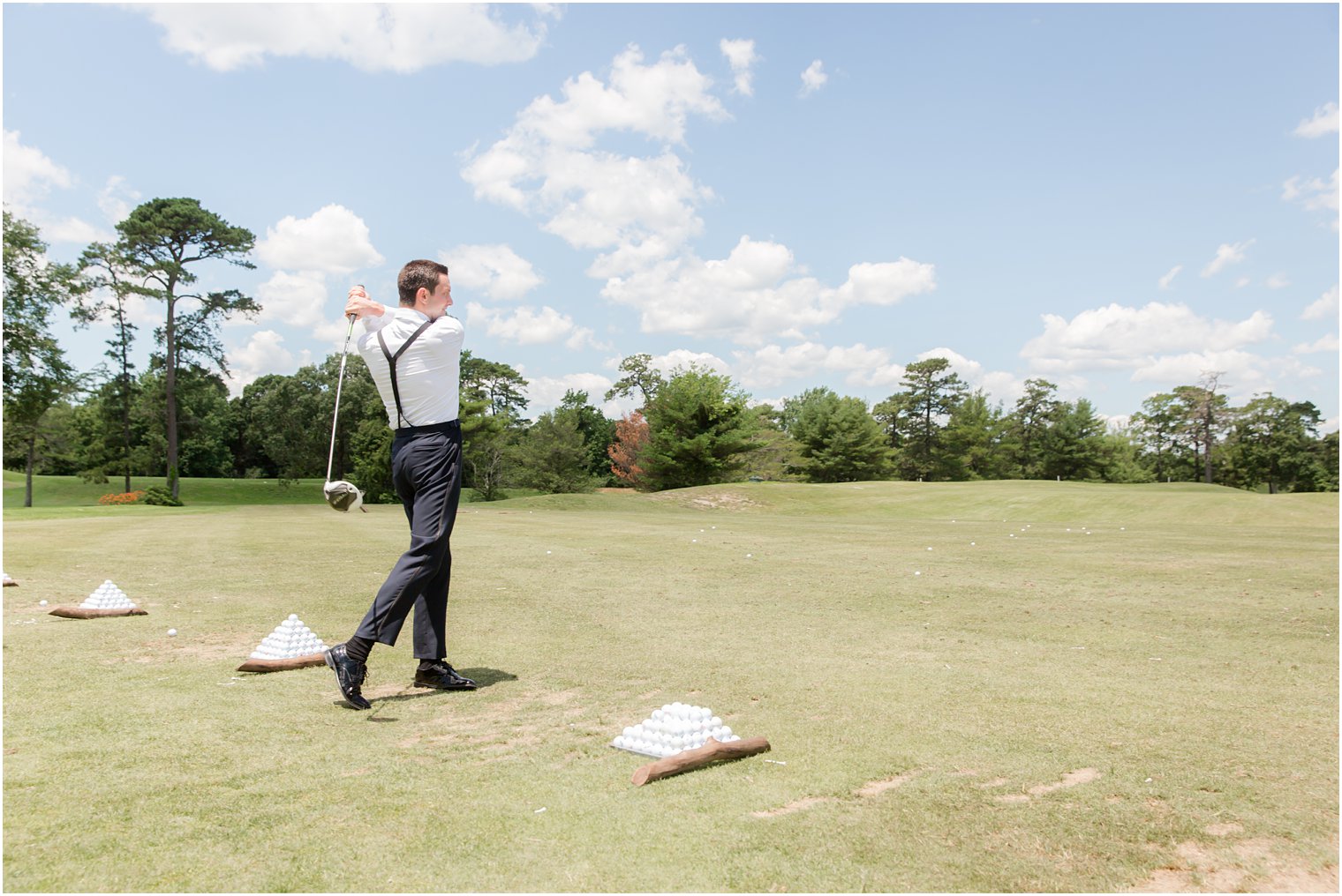 Groom playing golf at Stone Harbor Golf Club Wedding Venue