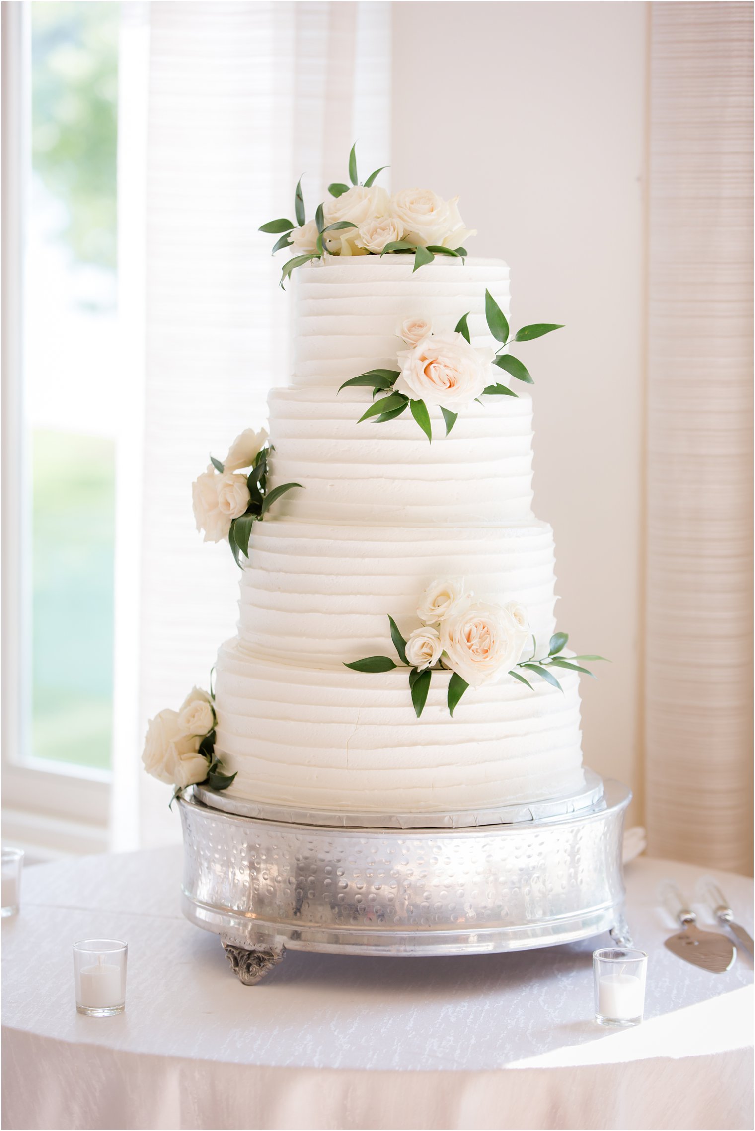 wedding cake with florals and greenery