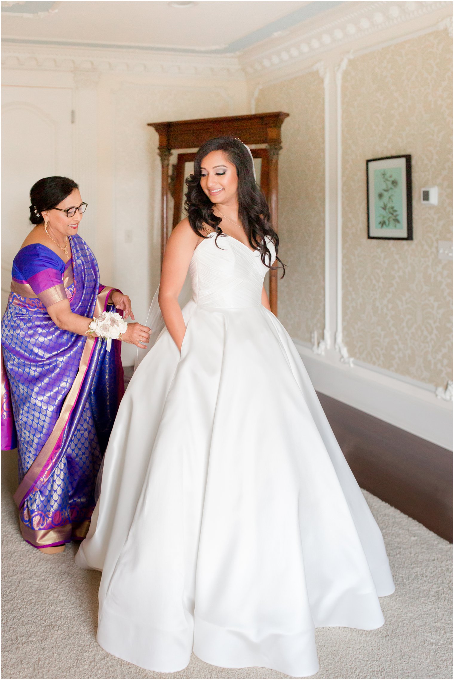 Bride getting ready with her mother on wedding morning