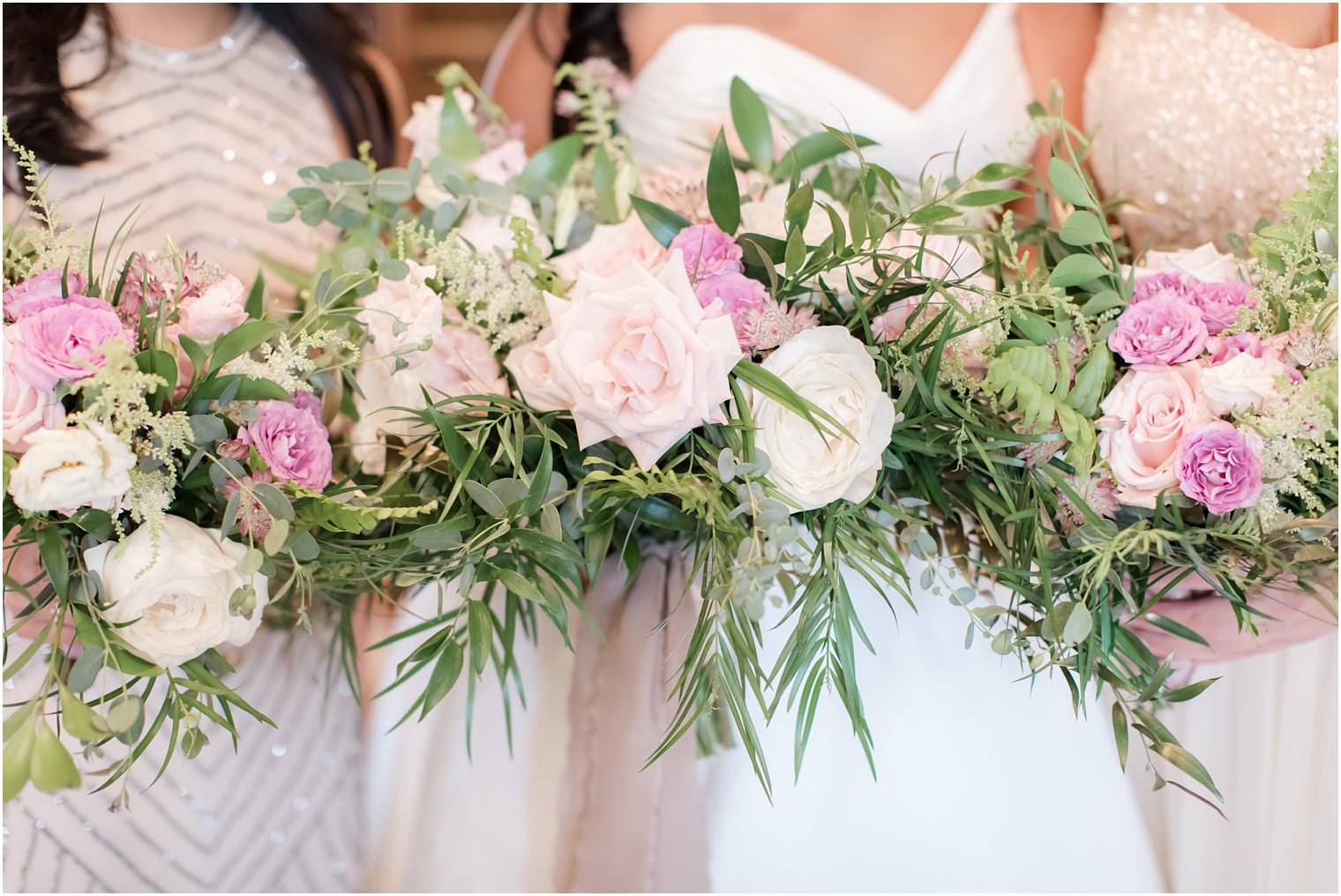 Bridesmaids in mismatched dresses with bouquets by Petal Pushers Magnolia