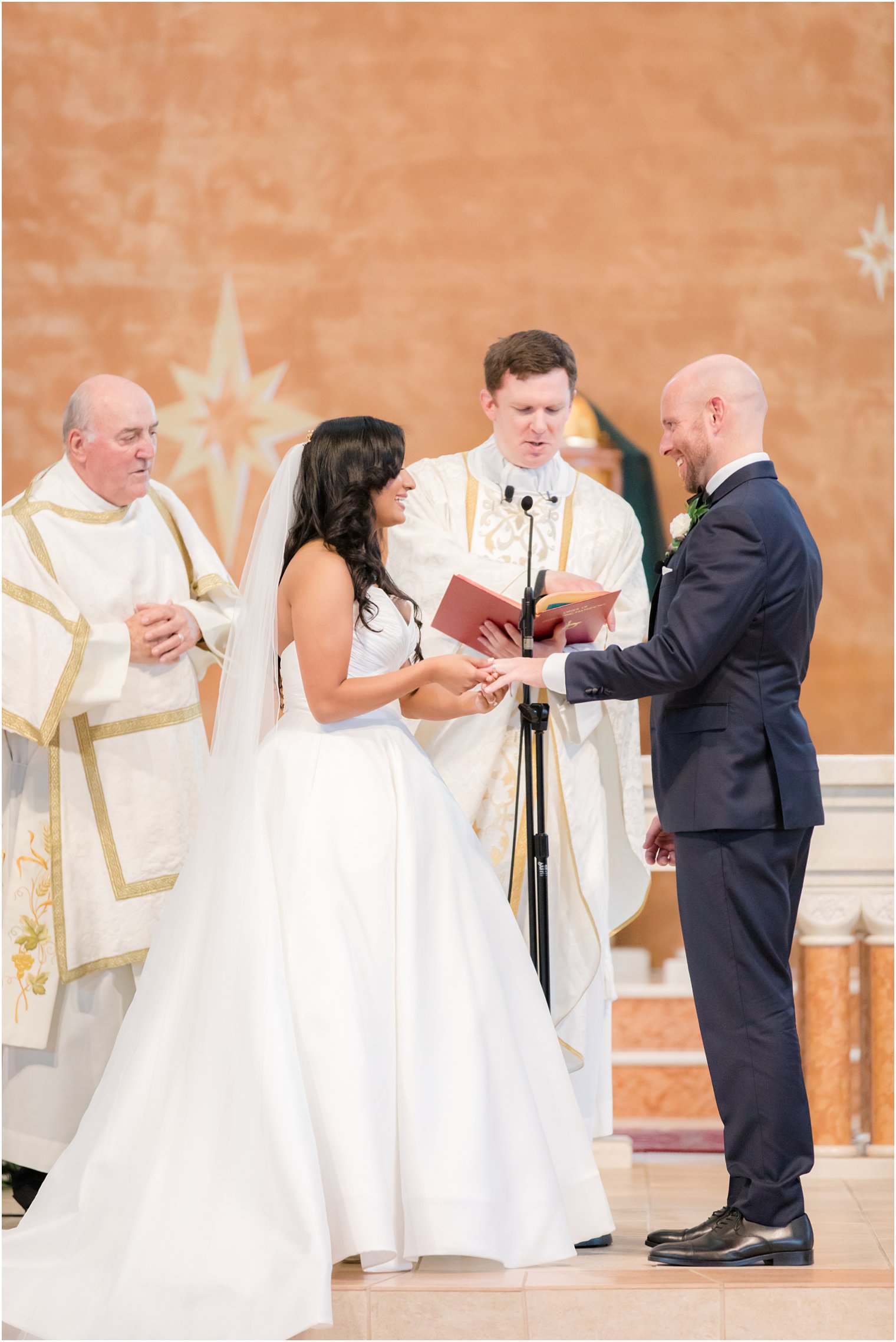 Exchange of rings at Wedding ceremony at St. Gregory the Great in Hamilton, NJ