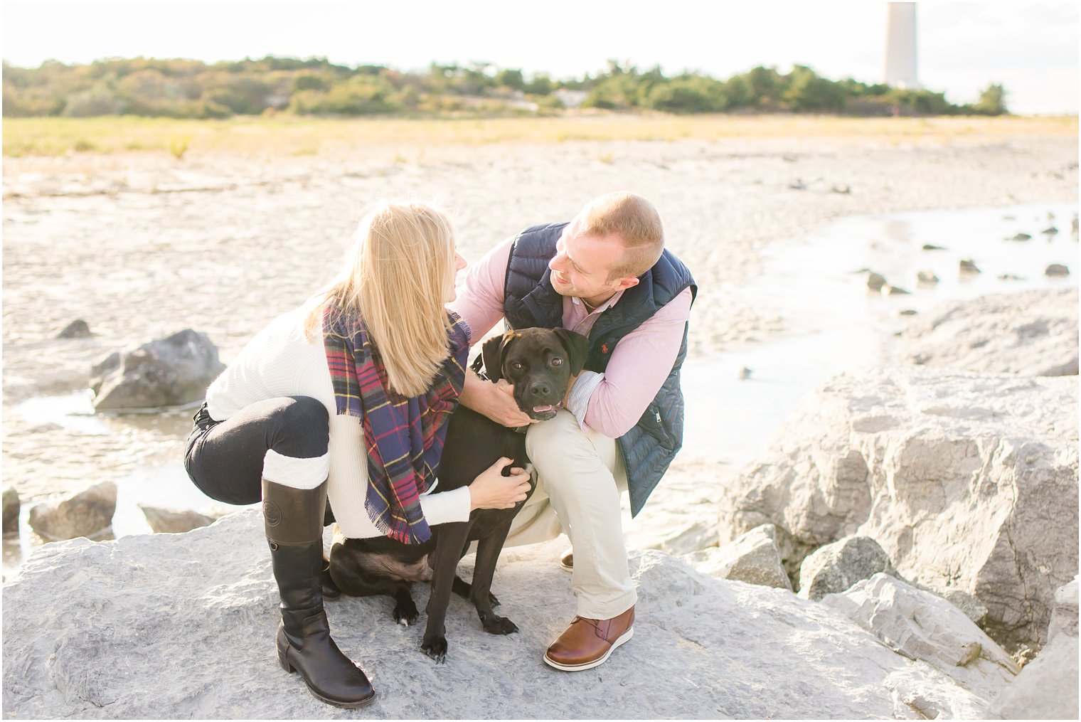 Photo of couple with dog during Barnegat Lighthouse Engagement Session by Idalia Photography