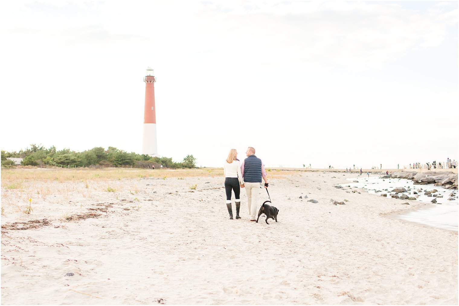 Romantic stroll during Barnegat Lighthouse Engagement Session by Idalia Photography