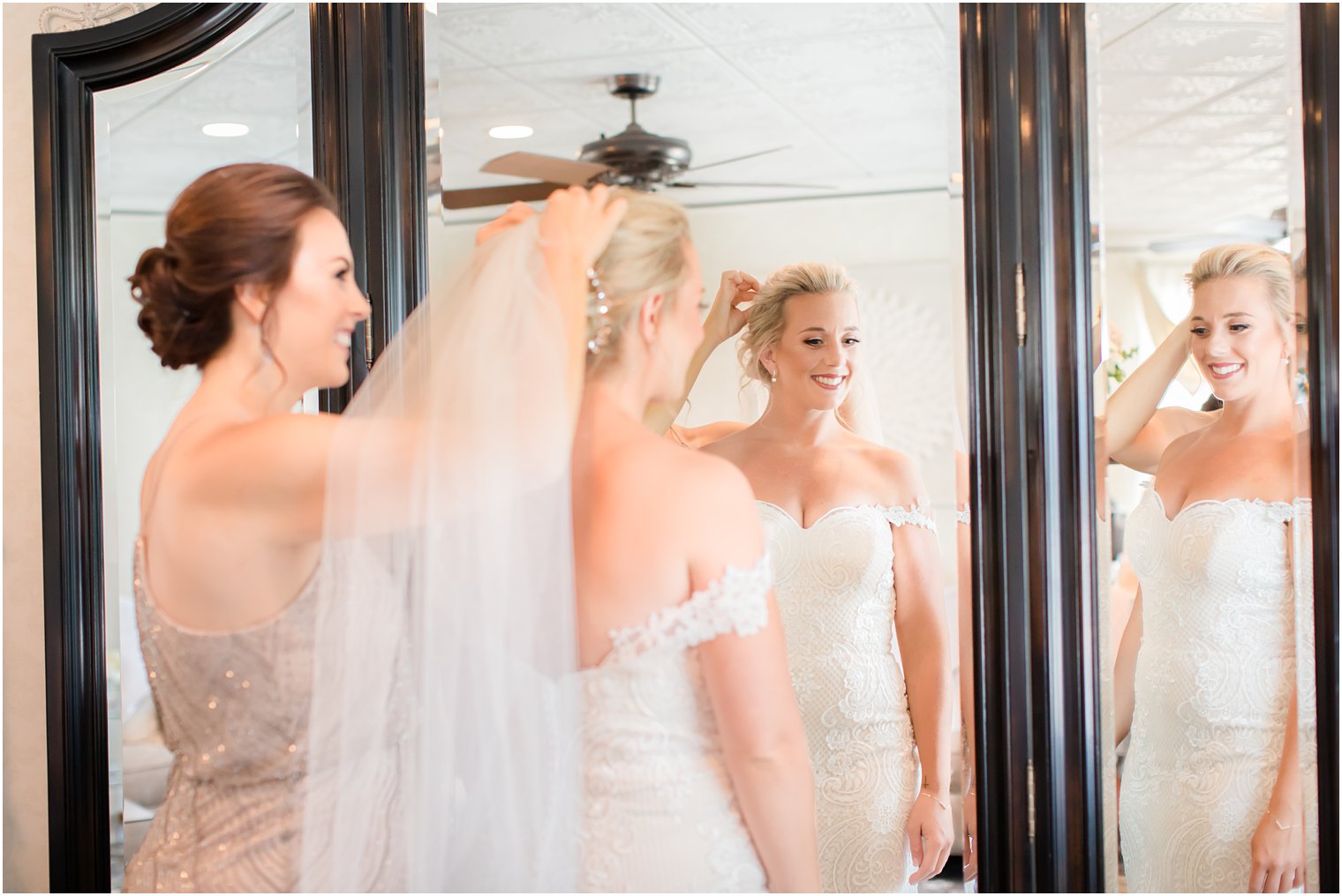 Bride having her veil put on by maid of honor