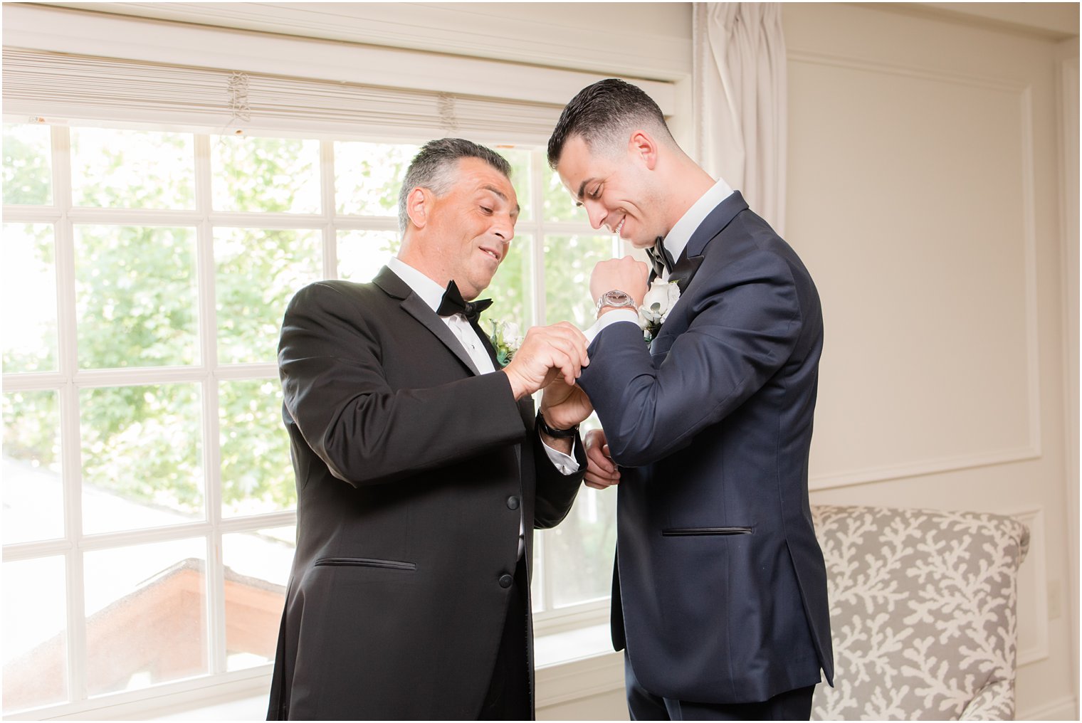 Groom's father helping him put on cufflinks