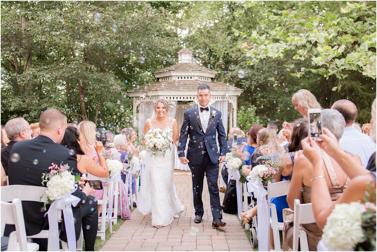 Bubble exit during outdoor ceremony at the Grain House at the Olde Mill Inn in Basking Ridge, NJ