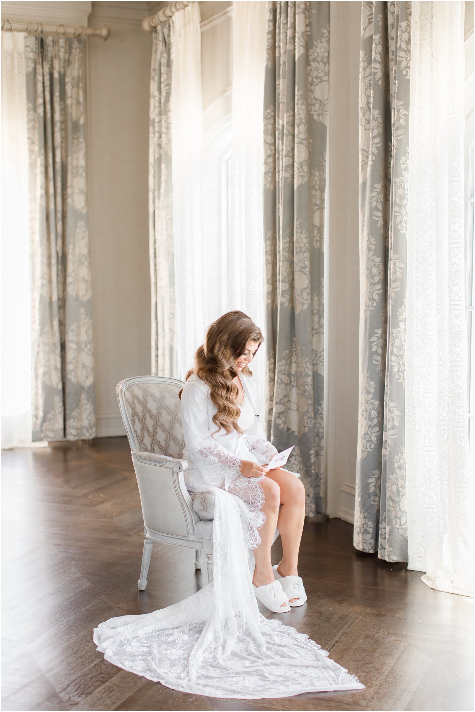 Bride reading letter from groom in Park Chateau Estate bridal suite