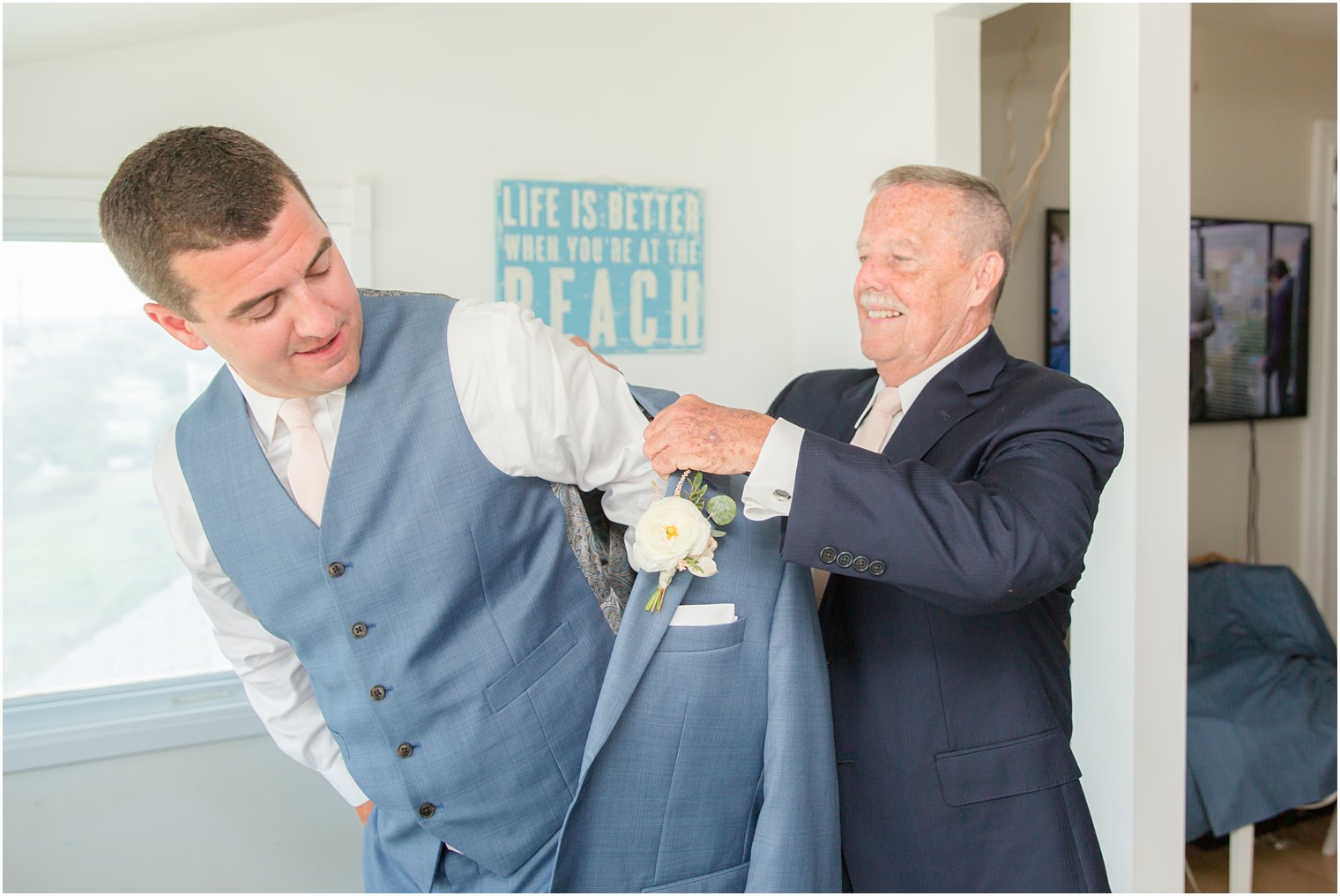 groom gets into suit with dad photographed by NJ wedding photographer Idalia Photography